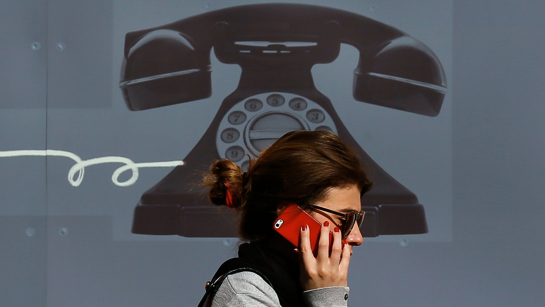 A woman uses her mobile phone in central London September 2, 2013. REUTERS/Stefan Wermuth