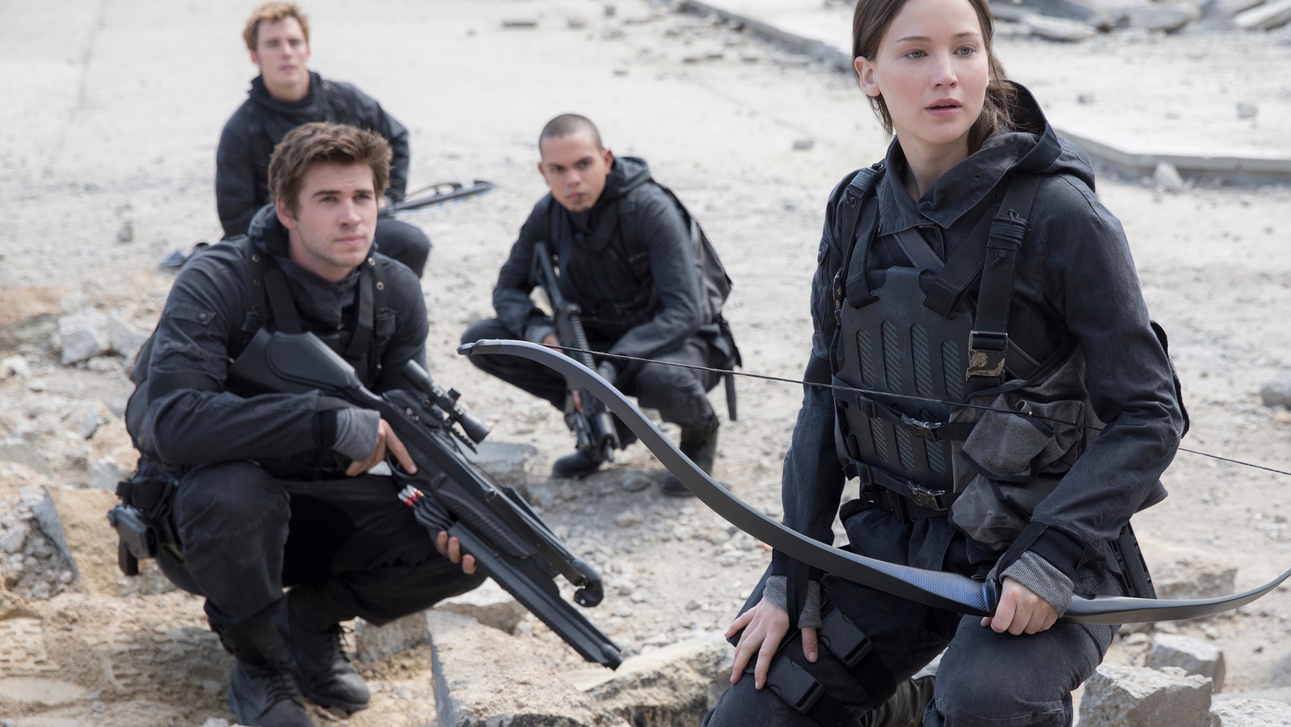 Liam Hemsworth, left, as Gale Hawthorne, Sam Clafin, back left, as Finnick Odair, Evan Ross, back right, as Messalia, and Jennifer Lawrence, right, as Katniss Everdeen, in the film, "The Hunger Games: Mockingjay - Part 2."
