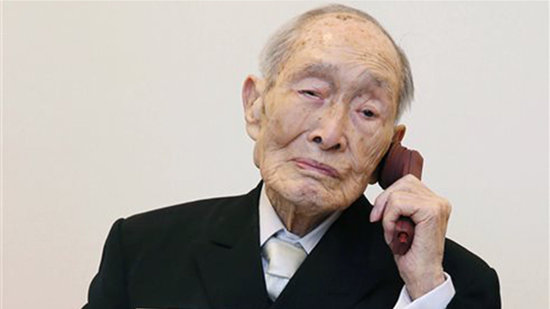 In this Aug. 20, 2014 file photo, Sakari Momoi, a Japanese retired educator, poses for a photo in Tokyo.