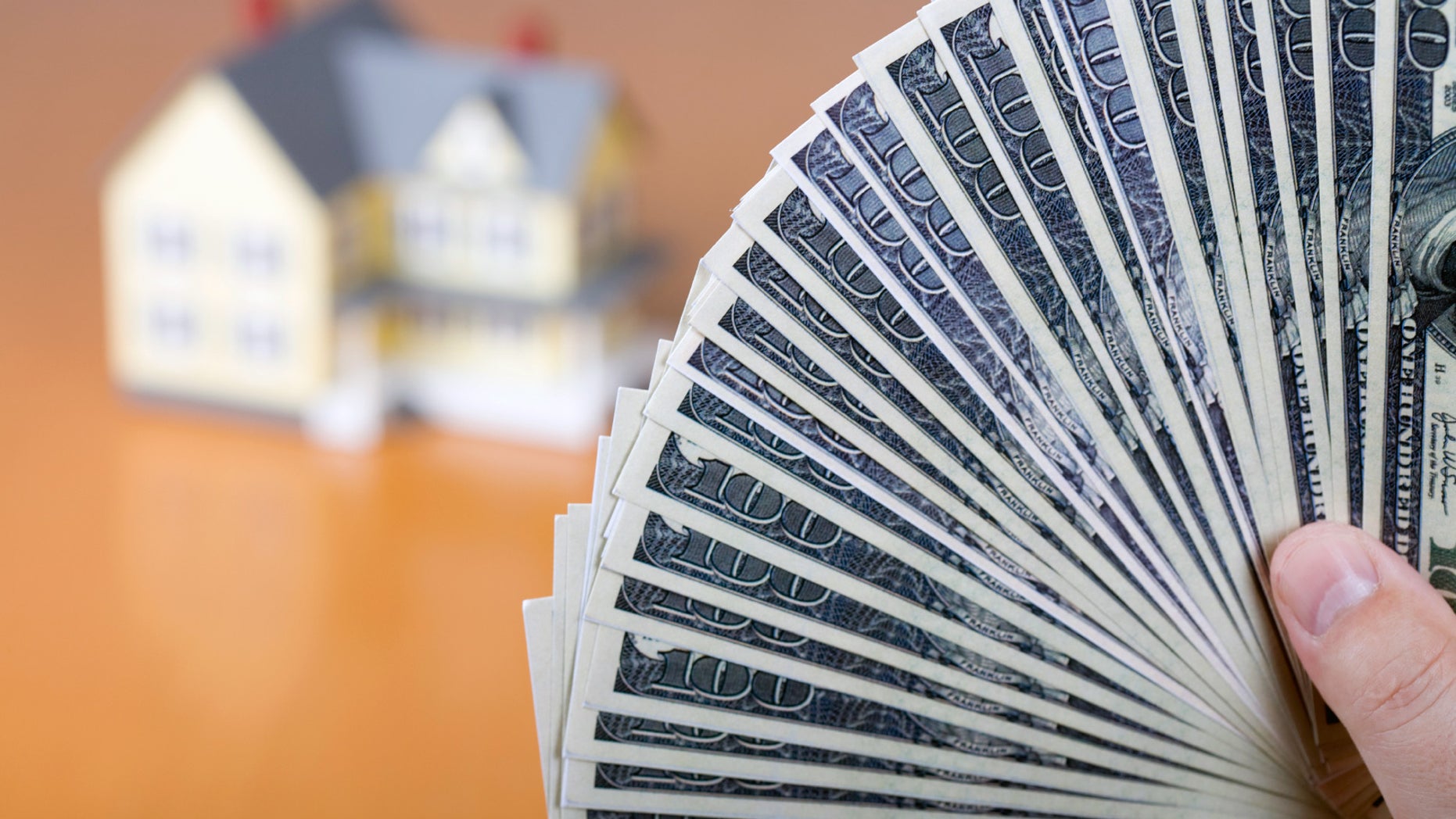 money-fanned-in-front-of-house