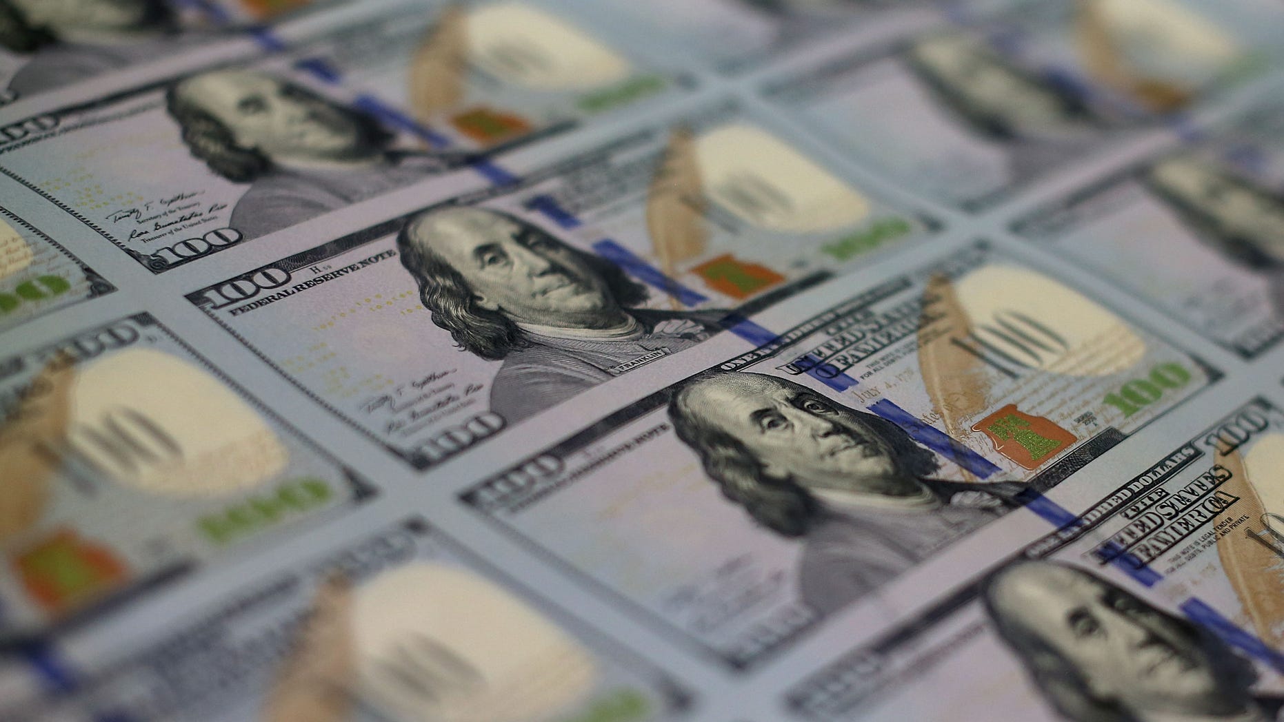 WASHINGTON, DC - MAY 20: Newly redesigned $100 notes lay in stacks at the Bureau of Engraving and Printing on May 20, 2013 in Washington, DC. The one hundred dollar bills will be released this fall and has new security features, such as a duplicating portrait of Benjamin Franklin and microprinting added to make the bill more difficult to counterfeit. (Photo by Mark Wilson/Getty Images)