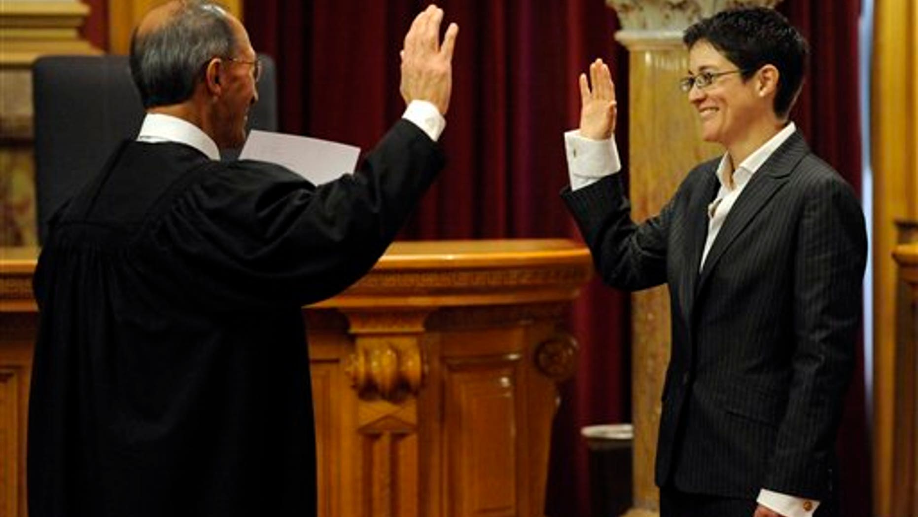 Monica Marquez is sworn in as a new State supreme court justice by her father, senior judge Jose Marquez, at the State Capitol Friday, Dec. 10, 2010, in Denver. Marquez replaced retired Chief Justice Mary Mullarkey. (AP Photo/Jack Dempsey)
