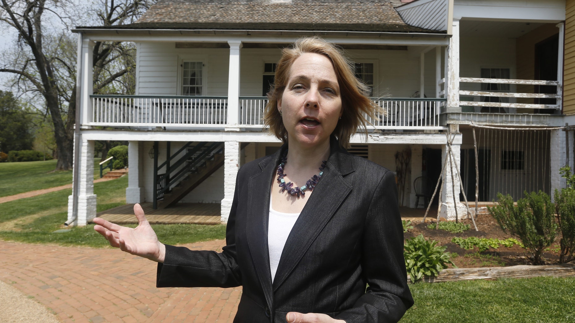 In this Thursday, April 21, 2016 photo, Executive Director of The James Monroe Highland Foundation, Sara Bon-Harper, gestures in front what was considered the home of former President James Monroe in Charlottesville, Va. The house which is shown from the back was a guest house built in 1818. (AP Photo/Steve Helber)