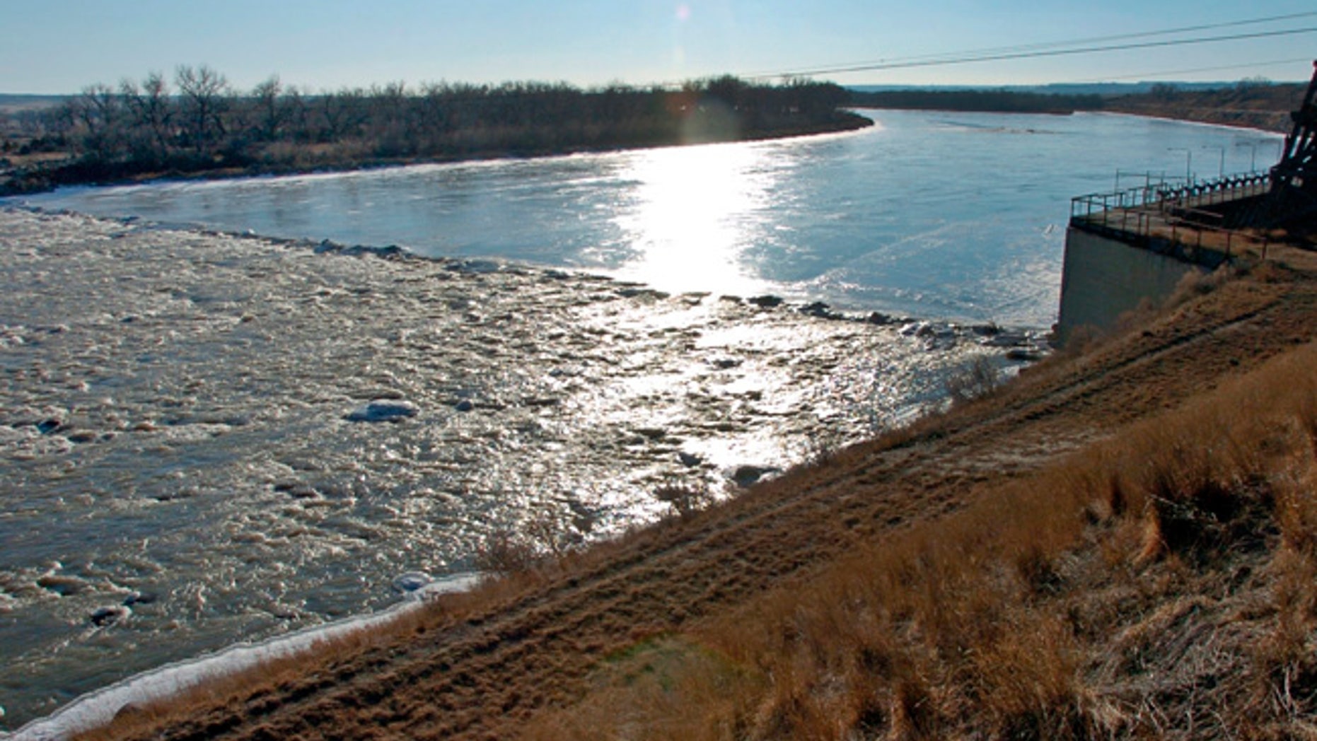 FILE - In this Feb. 26, 2015, file photo, the Yellowstone River flows over the Intake Diversion Dam, a rock structure that captures water for agriculture, northeast of Glendive, Mont., near the North Dakota border. A judge again blocked Wednesday, July 5, 2017, a proposed $59 million irrigation dam because of the potential threat to an ancient fish species in Montana's Yellowstone River. (AP Photo/Matthew Brown, File)