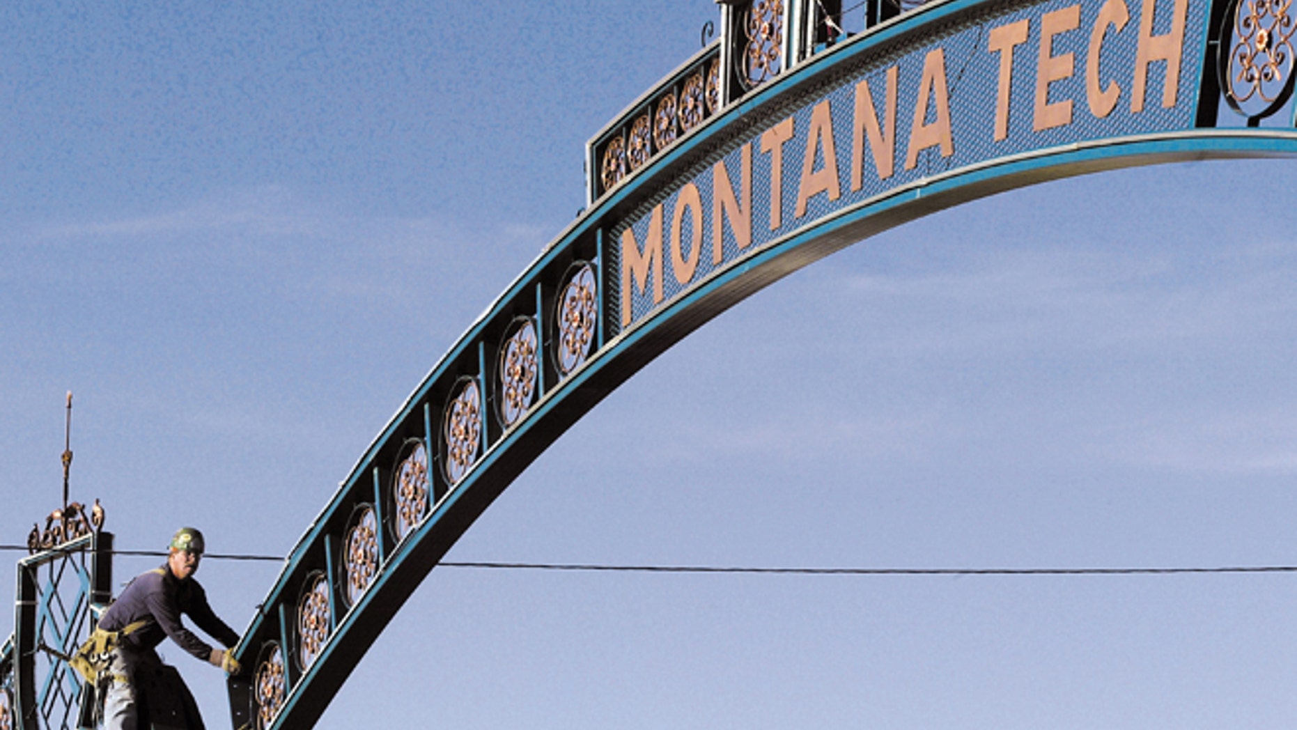 In this Aug. 26, 2003, file photo, Butch Schelin guides the new Montana Tech archway into place above Park Street in Butte, Mont. Montana Tech has expelled 15 summer school students for cheating.