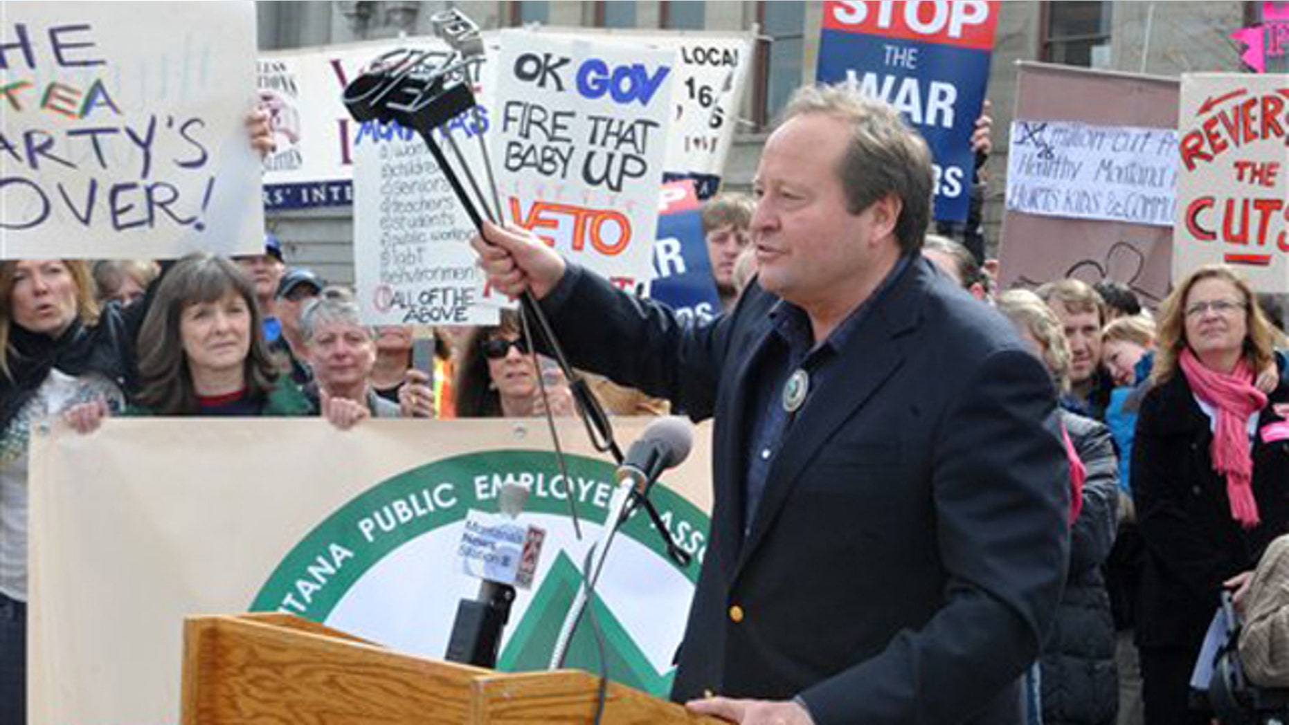 Montana Gov. Brian Schweitzer speaks in front of a crowd of protesters outside the Capitol in Helena, Mont., on April 1.