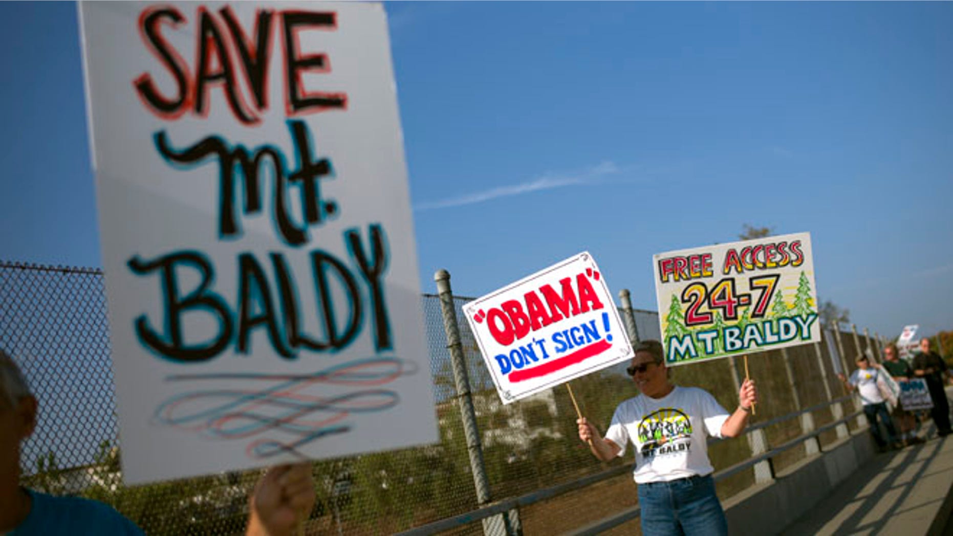 Oct. 10, 2014: Protesters hold signs to oppose President Barack Obama's designation of the San Gabriel Mountains as a national monument before Obama's visit to Frank G. Bonelli Regional Park in San Dimas, Calif.