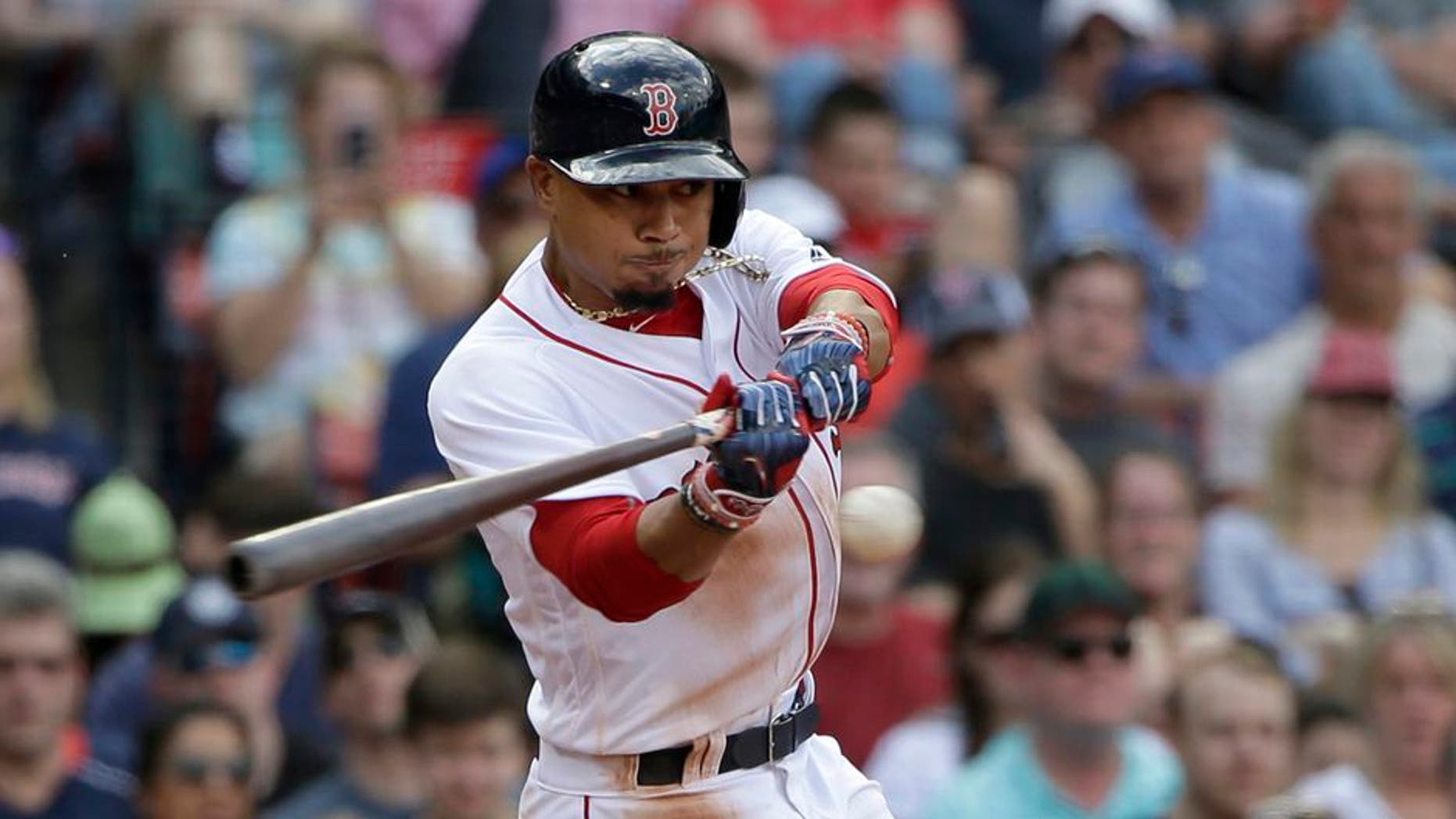 Boston Red Sox's Mookie Betts swings at a pitch in the seventh inning of a baseball game against the Tampa Bay Rays, Sunday, April 16, 2017, in Boston. (AP Photo/Steven Senne)