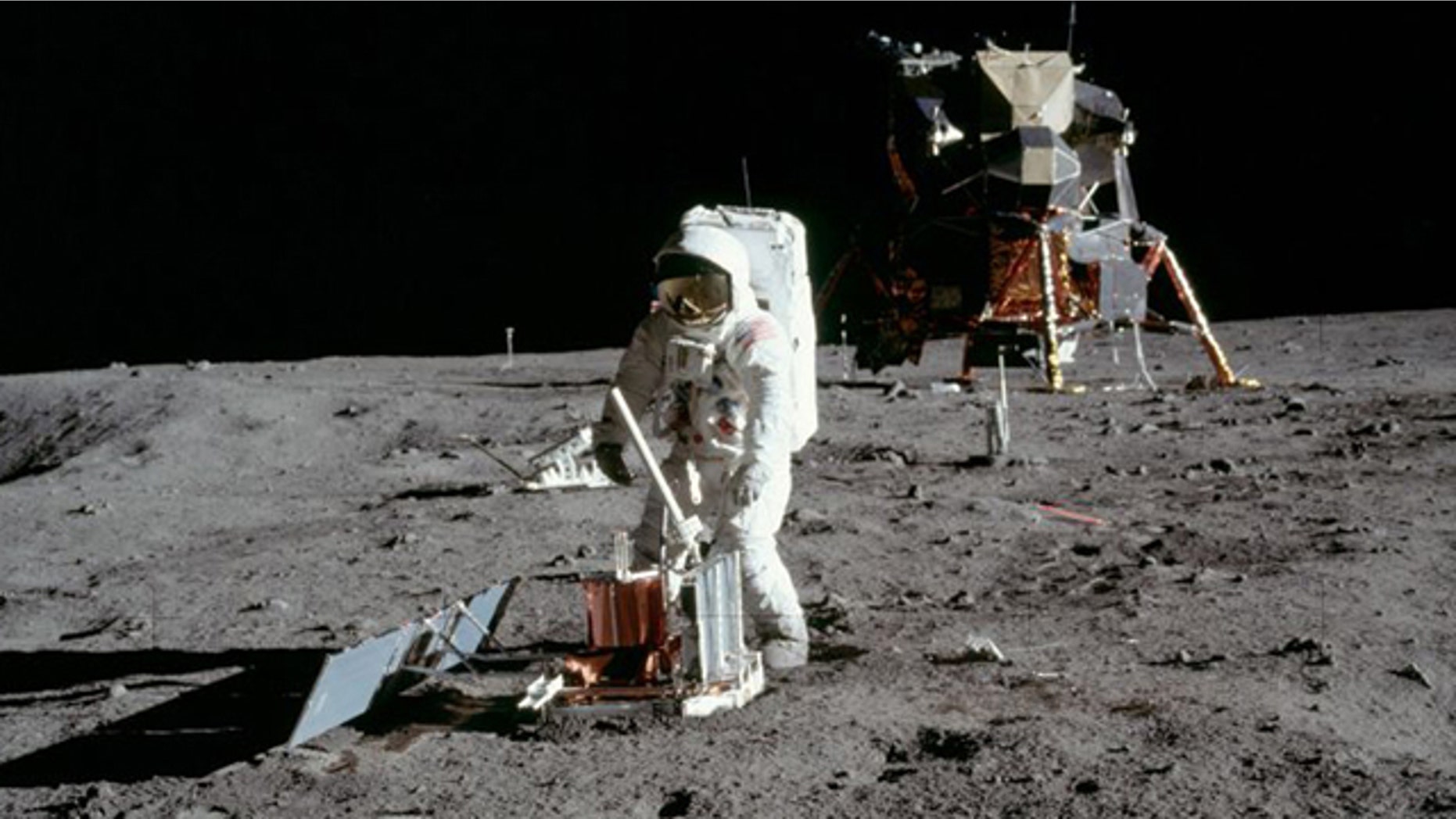 Buzz Aldrin deploys a seismometer in the Sea of Tranquillity area of the moon.