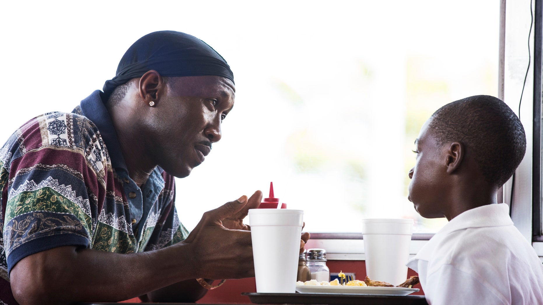 This image released by A24 Films shows Mahershala Ali, left, and Alex Hibbert in a scene from, "Moonlight." Ali was nominated for an Oscar for best supporting actor on Tuesday, Jan. 24, 2017, for his work in the film. The 89th Academy Awards will take place on Feb. 26. (David Bornfriend/A24 via AP)