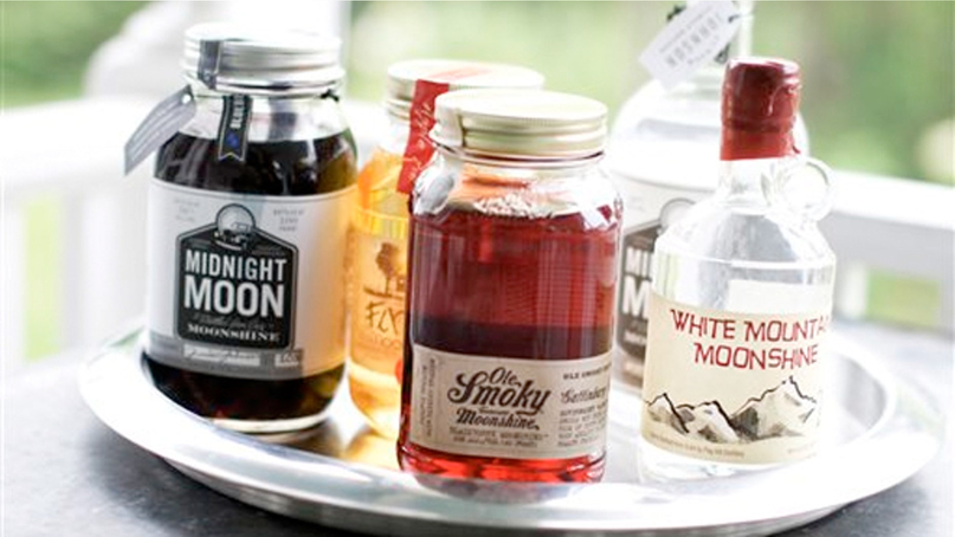 June 10, 2013: Midnight Moon Blueberry, FireFly Moonshine Apple Pie Flavor, Ole Smoky Tennessee Moonshine Blackberry, Midnight Moon Moonshine, and White Mountain Moonshine are shown in Concord, N.H.