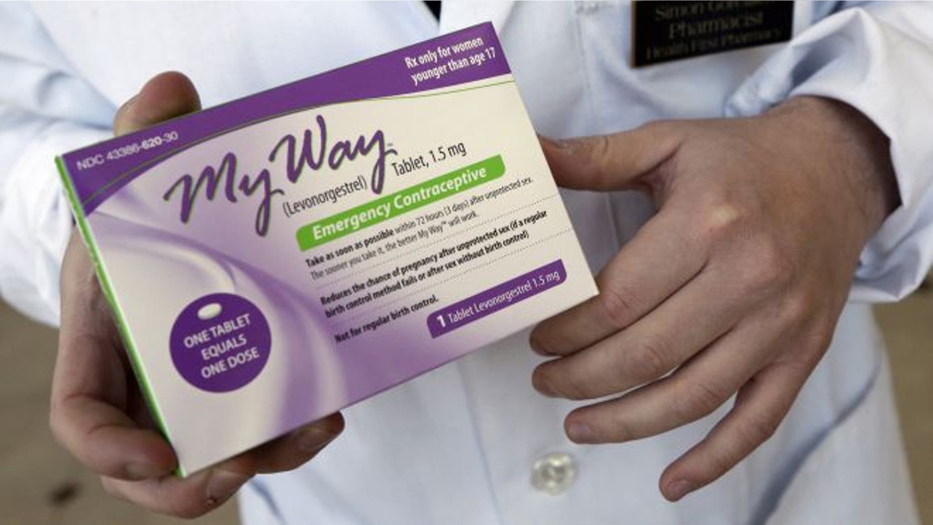 May 2, 2013 file photo, pharmacist Simon Gorelikov holds a generic emergency contraceptive at the Health First Pharmacy in Boston.