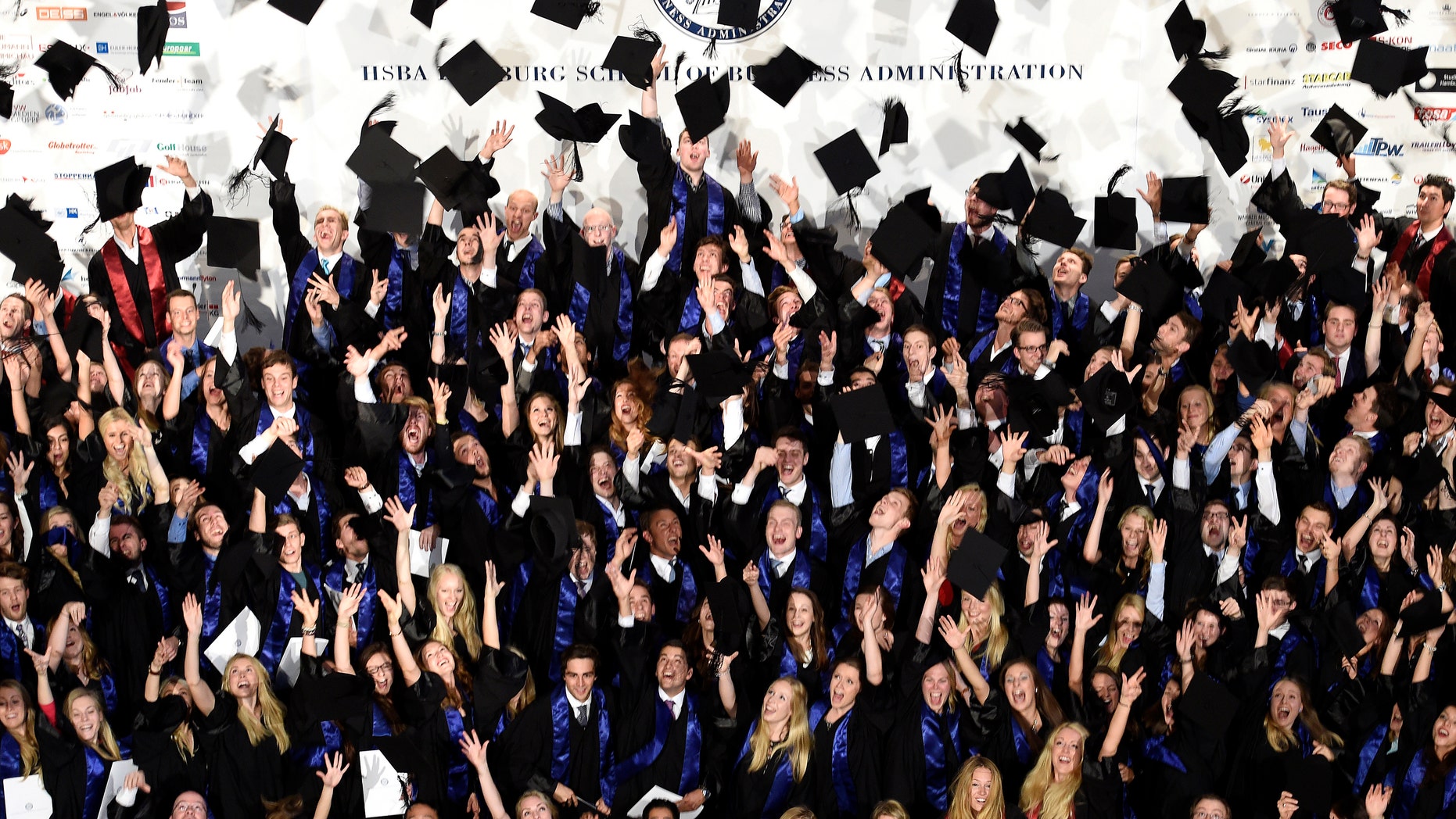File photo - Students throw their mortarboards after their graduation ceremony at the Hamburg School of Business Administration (HSBA) in Hamburg, Oct. 1, 2014. (REUTERS/Fabian Bimmer)