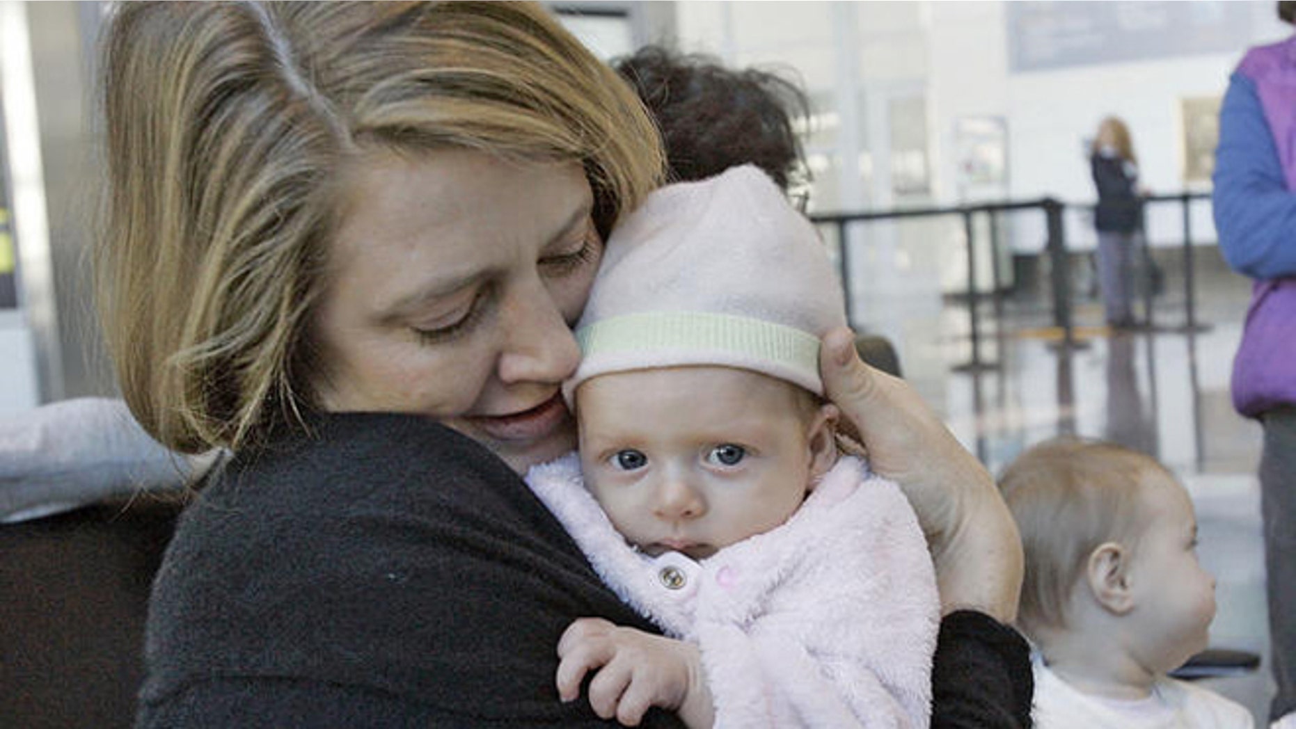 Lissa Pierce Bonifaz , left, of Boston, holds her 11-week-old baby, Marisol, during a breast-feeding rally near the Delta Airlines ticket counter at Logan International Airport in Boston, Tuesday, Nov. 21, 2006, as Alison Yaker, of Somerville, Mass., holds her 6 month-old son, Charlie. At center is Ruth Leib, 8 month-old, who attended the rally with her mother Joan, not seen. Mothers were there to protest the removal of a nursing mother from a Delta Airlines commuter flight in Burlington, Vt. (AP Photo/Chitose Suzuki)