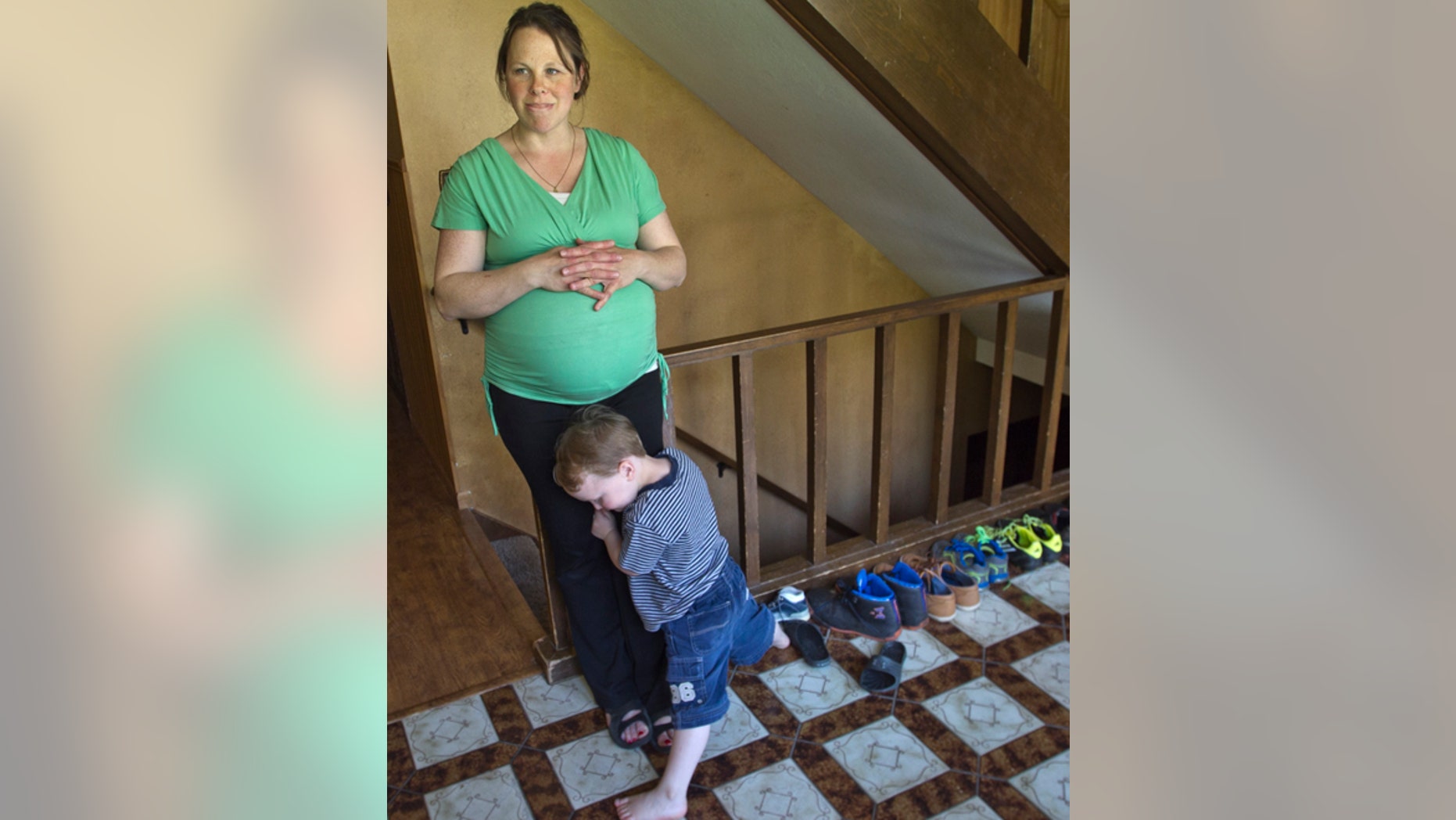 Kateri Schwandt shares a moment with her son, Luke, 3, inside their Rockford, Mich., home Wednesday, May 6, 2015. Schwandt and her husband, Jay, have 12 boys. They are expecting a baby on May 9, the day before Mother's Day, and they're sticking to their tradition of not finding out in advance whether they're having a boy or girl. (Chris Clark/The Grand Rapids Press via AP)