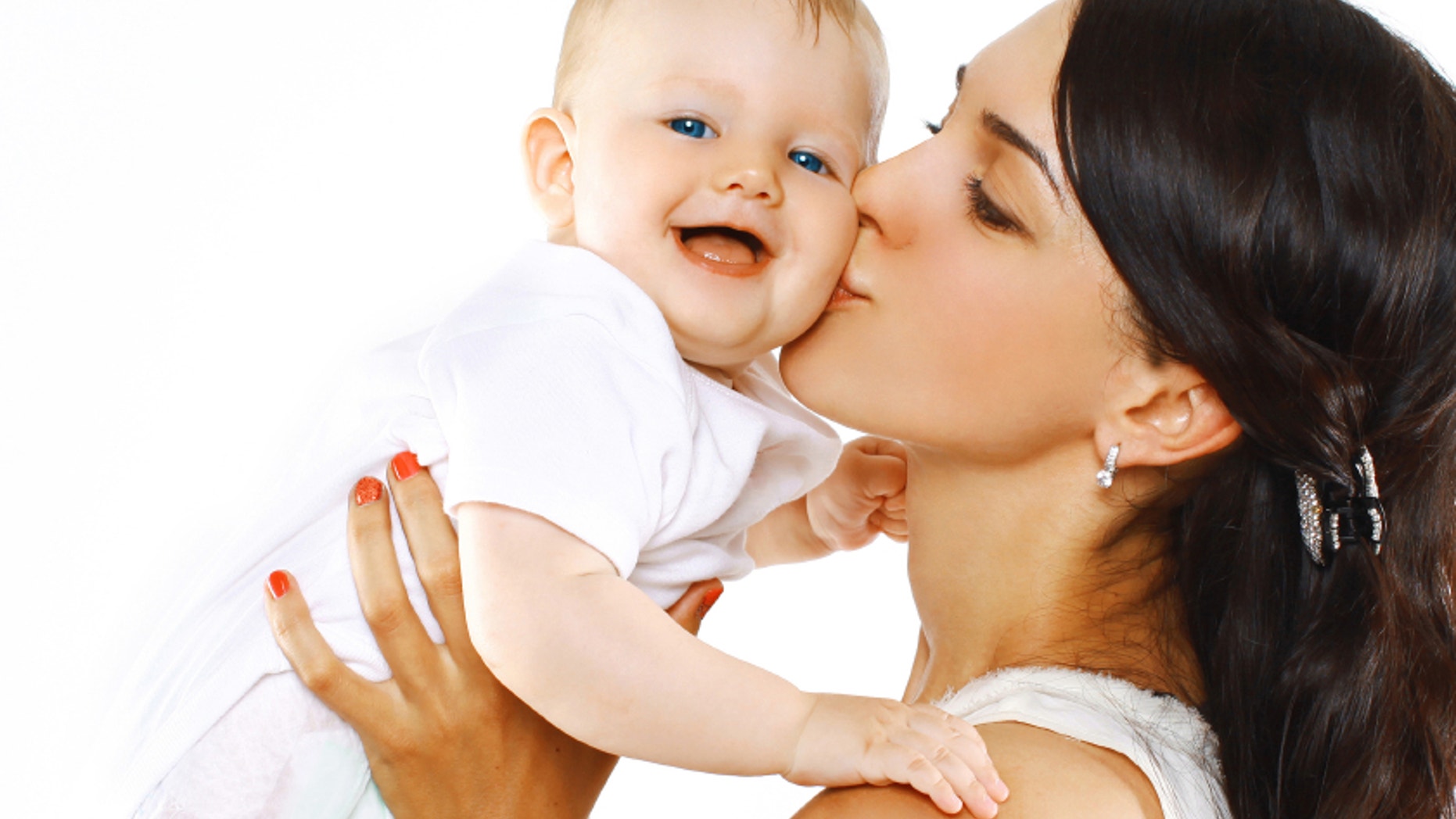 Happy family mother kissing baby