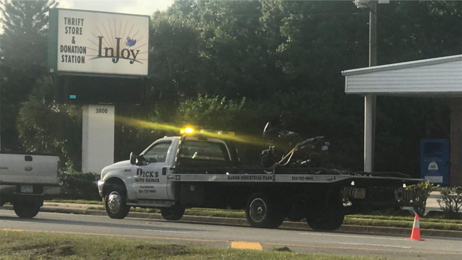 Alexander's motorcycle is loaded onto a truck following the accident.