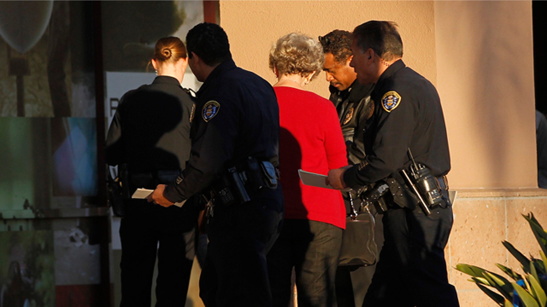 Jan. 12, 2013: Police officers talk with a witness near a shooting at the Reading Cinemas in San Diego.