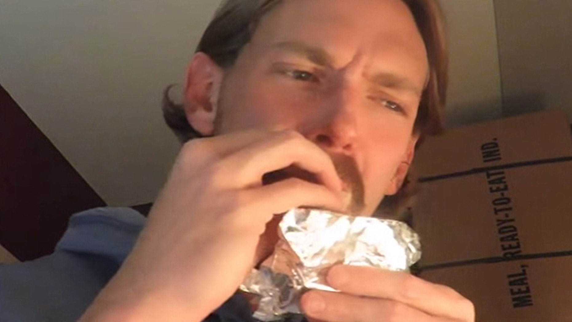 A ration reviewer who goes by Steve1989 samples chocolate from an MRE issued during World War II.
