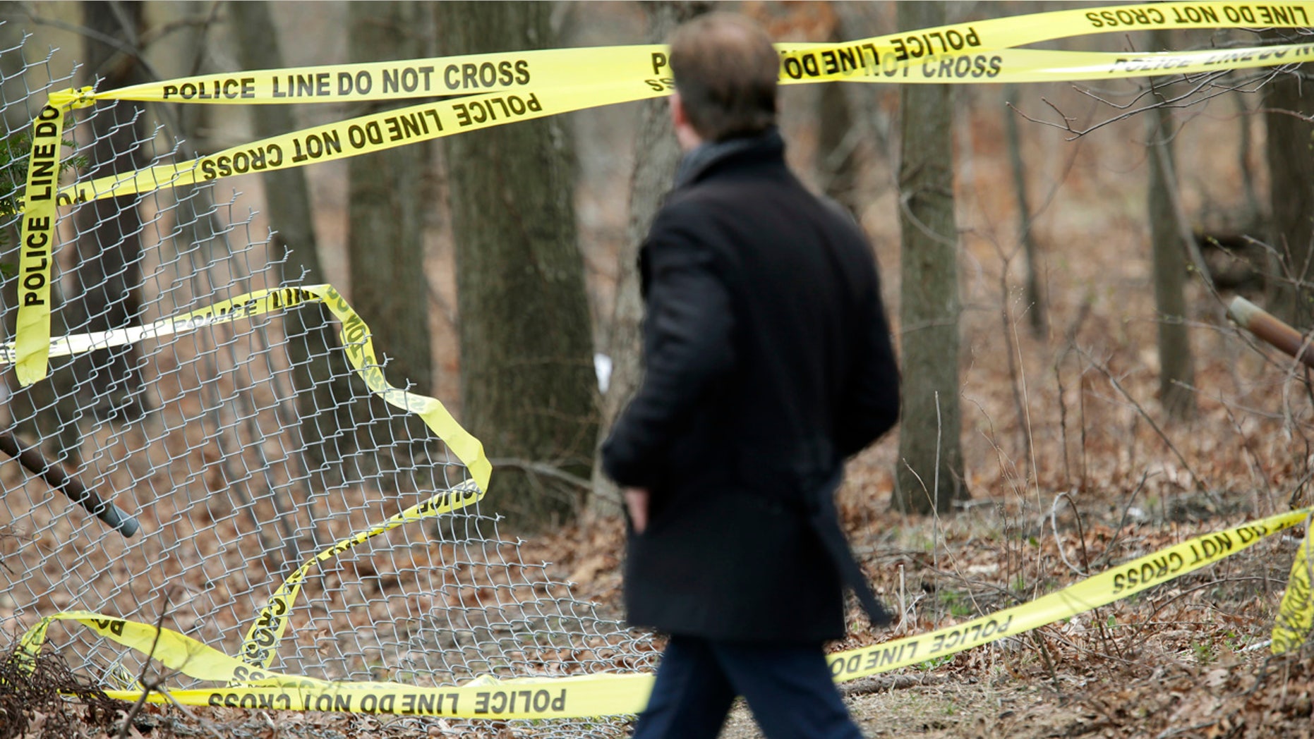 Police tape is seen in a wooded area in Long Island, New York where remains were discovered. It is believed that the victims were killed by MS-13 gang members.