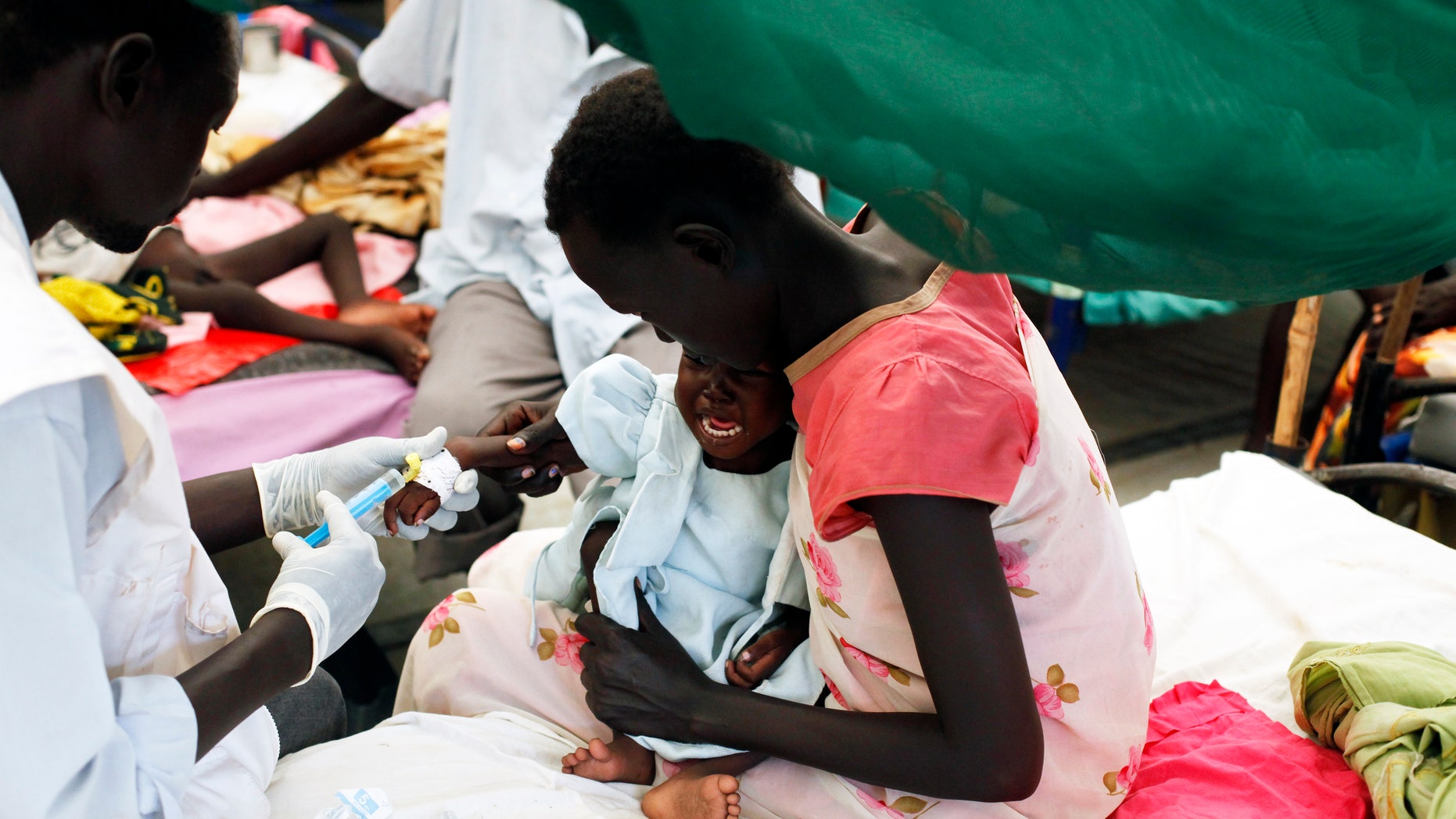 A medical staff attends to a malnourished child at a Medecins Sans Frontieres (MSF) hospital in an internally displaced persons (IDP) camp inside the U.N. base in Malakal, July 24, 2014. REUTERS/Andreea Campeanu