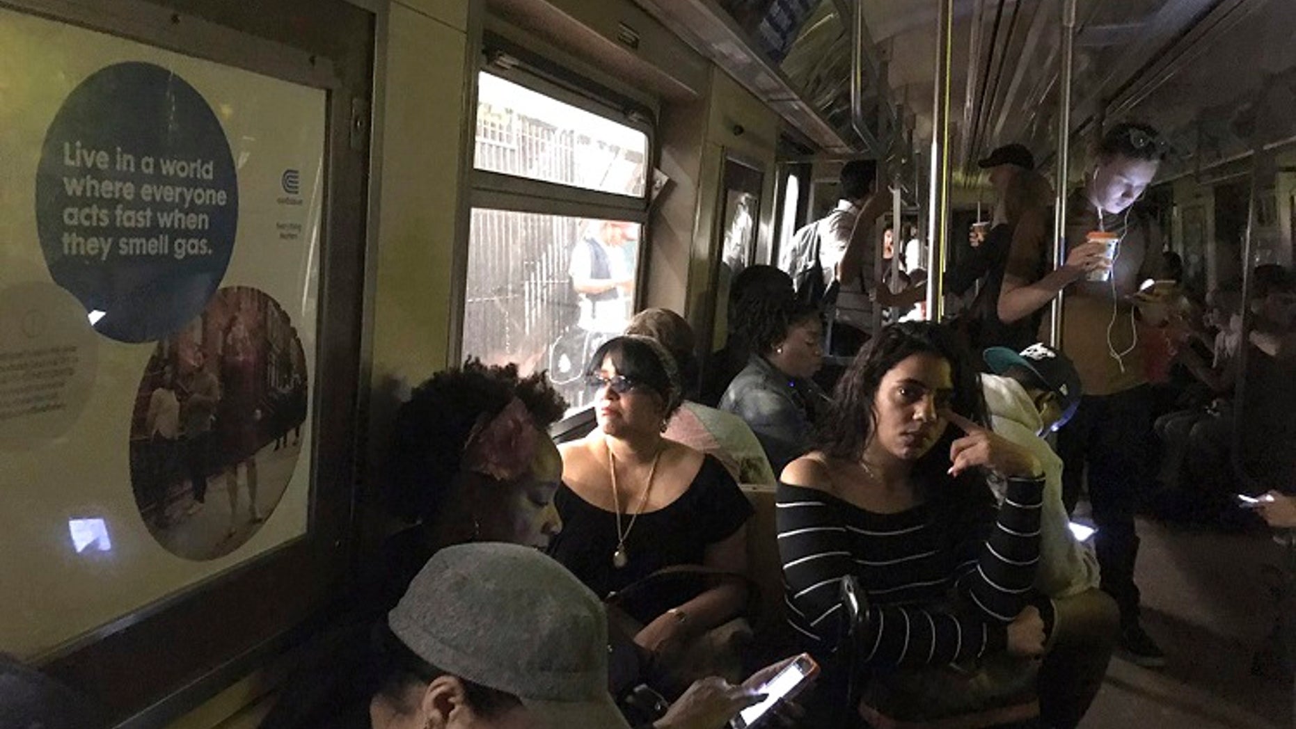 New York City subway passengers wait on the “A” train that derailed on Tuesday, June 27, 2017.