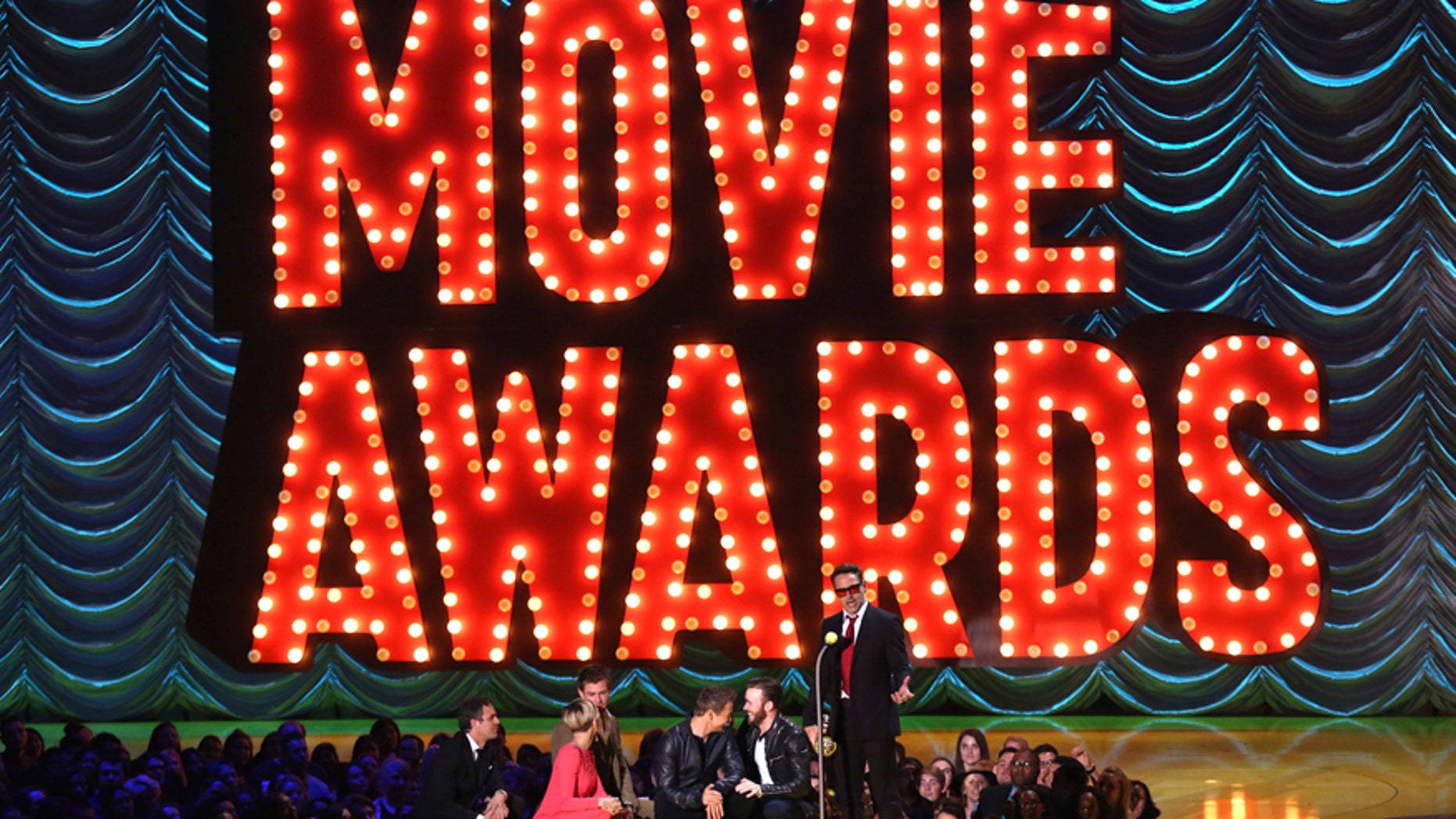 In this April 12, 2015 file photo, Mark Ruffalo, from left, Scarlett Johansson, Chris Hemsworth, Jeremy Renner, and Chris Evans present Robert Downey Jr. with the generation award at the MTV Movie Awards in Los Angeles. MTV announced April 6, 2017, that it has scrapped gender specific categories for its upcoming Movie & TV Awards. This the first year the MTV Movie Awards has been redubbed the Movie & TV Awards.