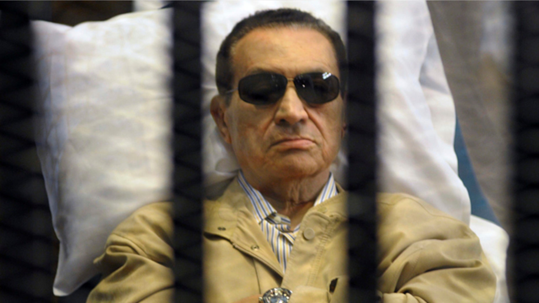 June 2, 2012: Egypt's ex-President Hosni Mubarak lays on a gurney inside a barred cage in the police academy courthouse in Cairo, Egypt.