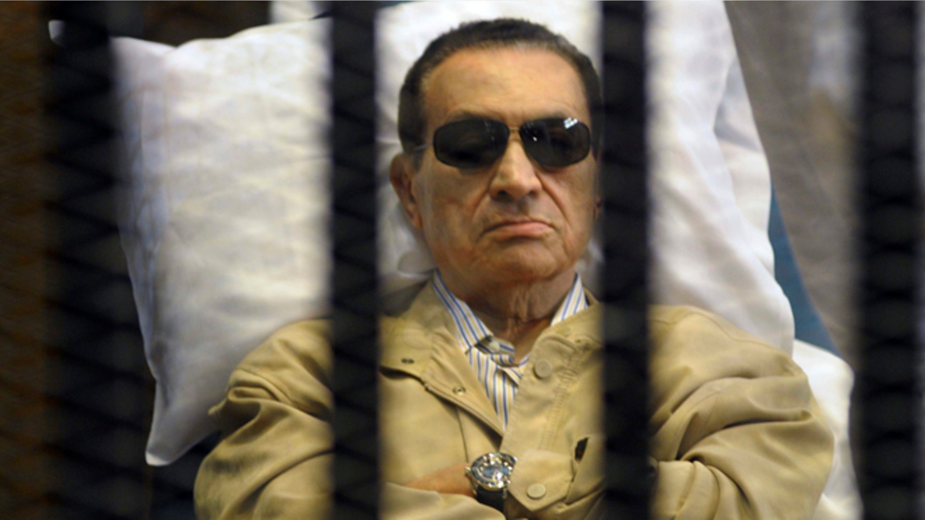 June 2, 2012: In this file photo, Egypt's ex-President Hosni Mubarak lays on a gurney inside a barred cage in the police academy courthouse in Cairo, Egypt.