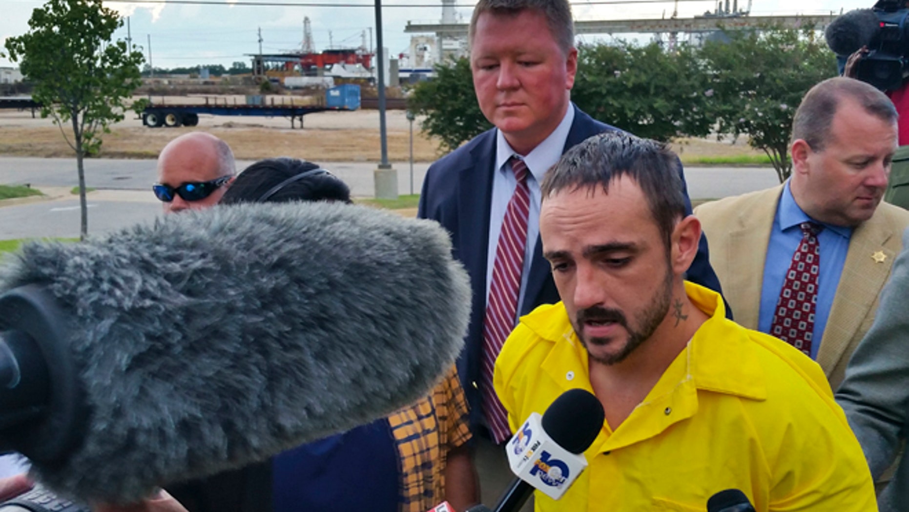 In this Monday, Aug. 22, 2016, photo, Derrick Dearman, 27, of Leakesville, Miss., center, is escorted into Mobile County Metro Jail in Mobile, Ala.