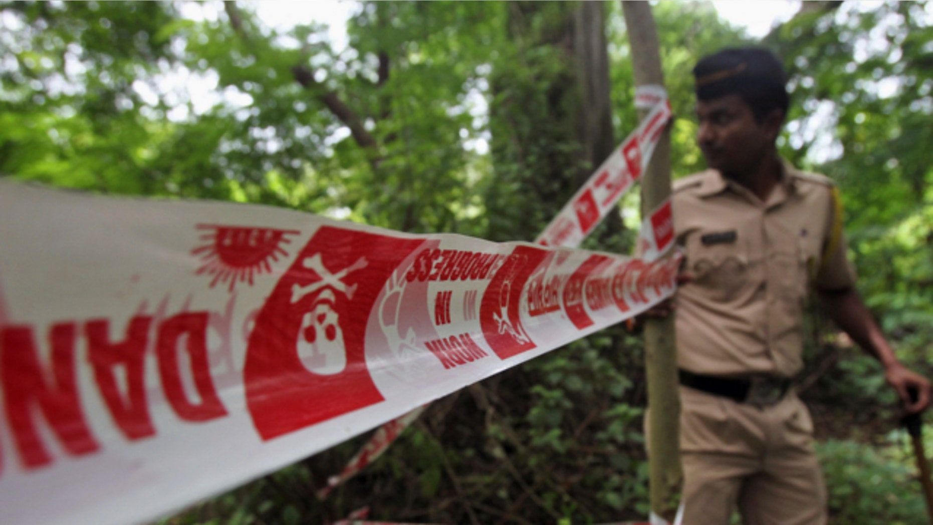 Aug. 23, 2013: An Indian policeman inspects the site where a 22-year-old woman was gang raped in Mahalaxmi area in Mumbai India.