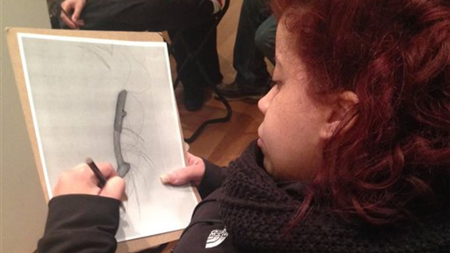 In this March 22, 2015 photo, Luz Cantres works on a drawing at the Museum of Modern Art in New York after viewing a sculpture by French artist Jean Dubuffet. (AP Photo/Ula Ilnytzky)