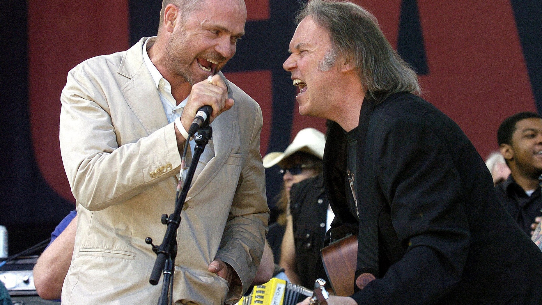 In this July 2, 2005, file photo, Gord Downie of The Tragically Hip (left) and Neil Young perform during the finale of the Canadian Live 8 concert in Barrie, Ont.