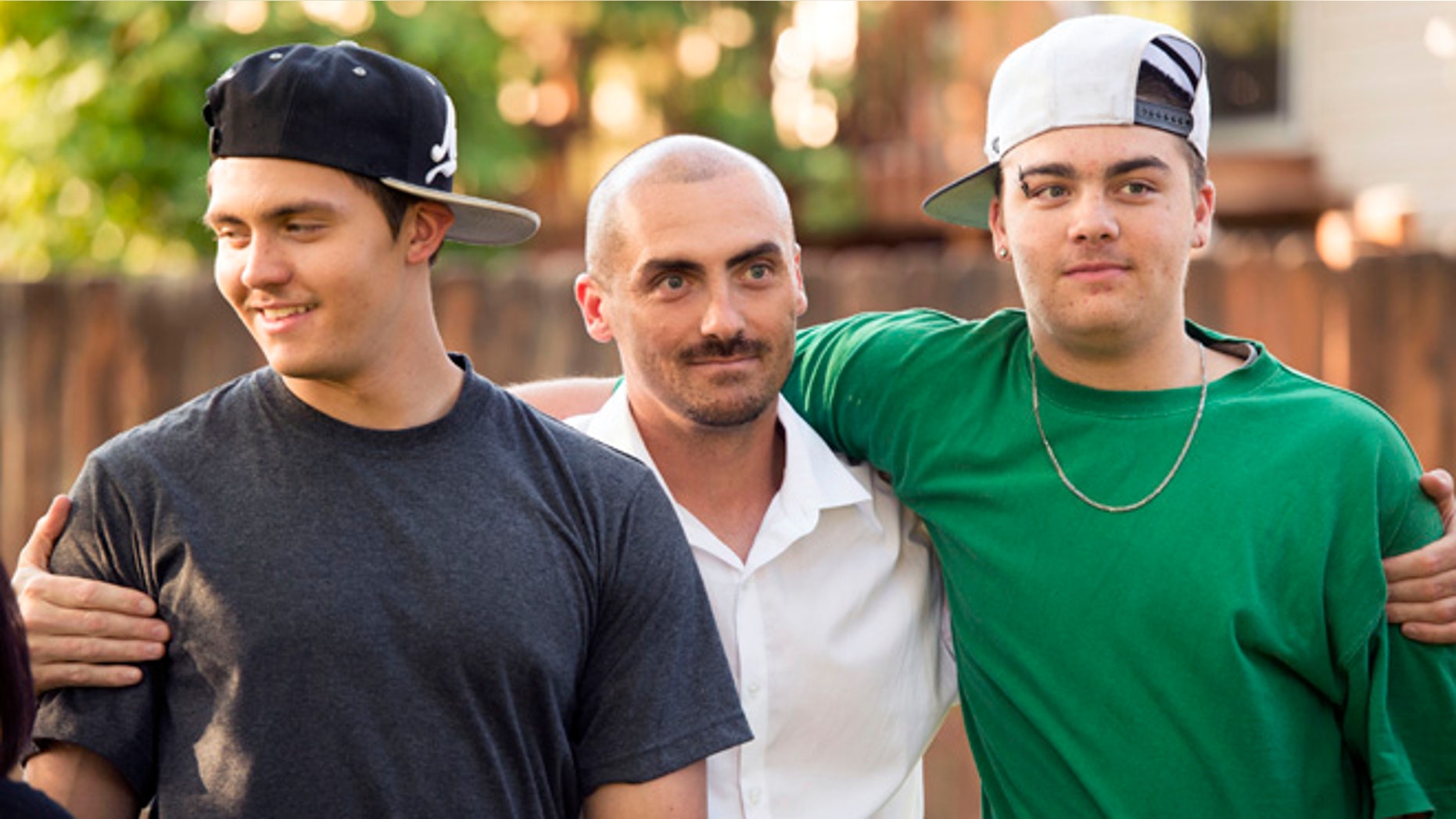 Weldon Angelos, center, holds his sons after being released from prison.