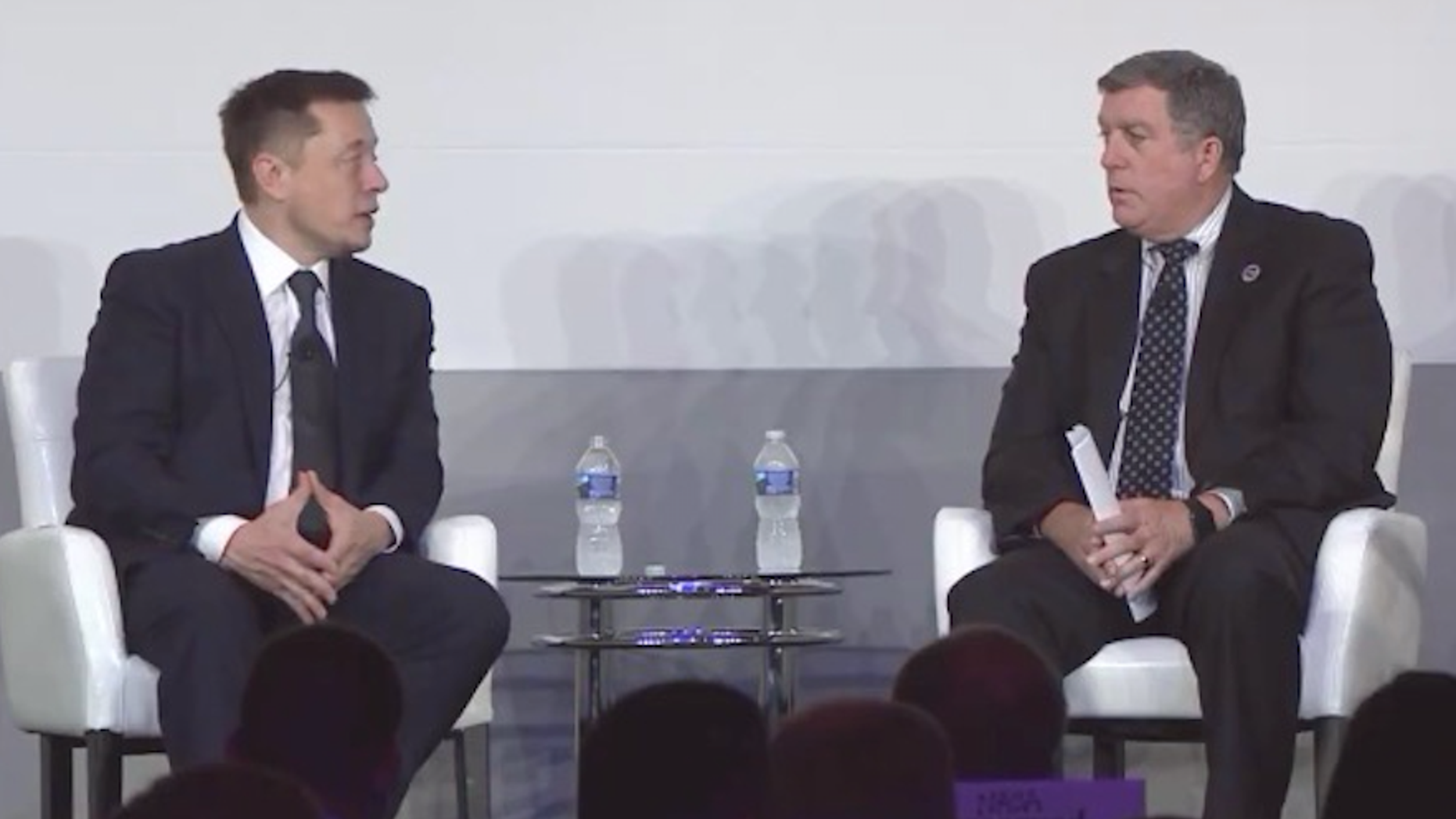 Elon Musk (left) talks to NASA International Space Station (ISS) program manager Kirk Shireman on July 19, 2017, at the ISS Research and Development conference in Washington, D.C.