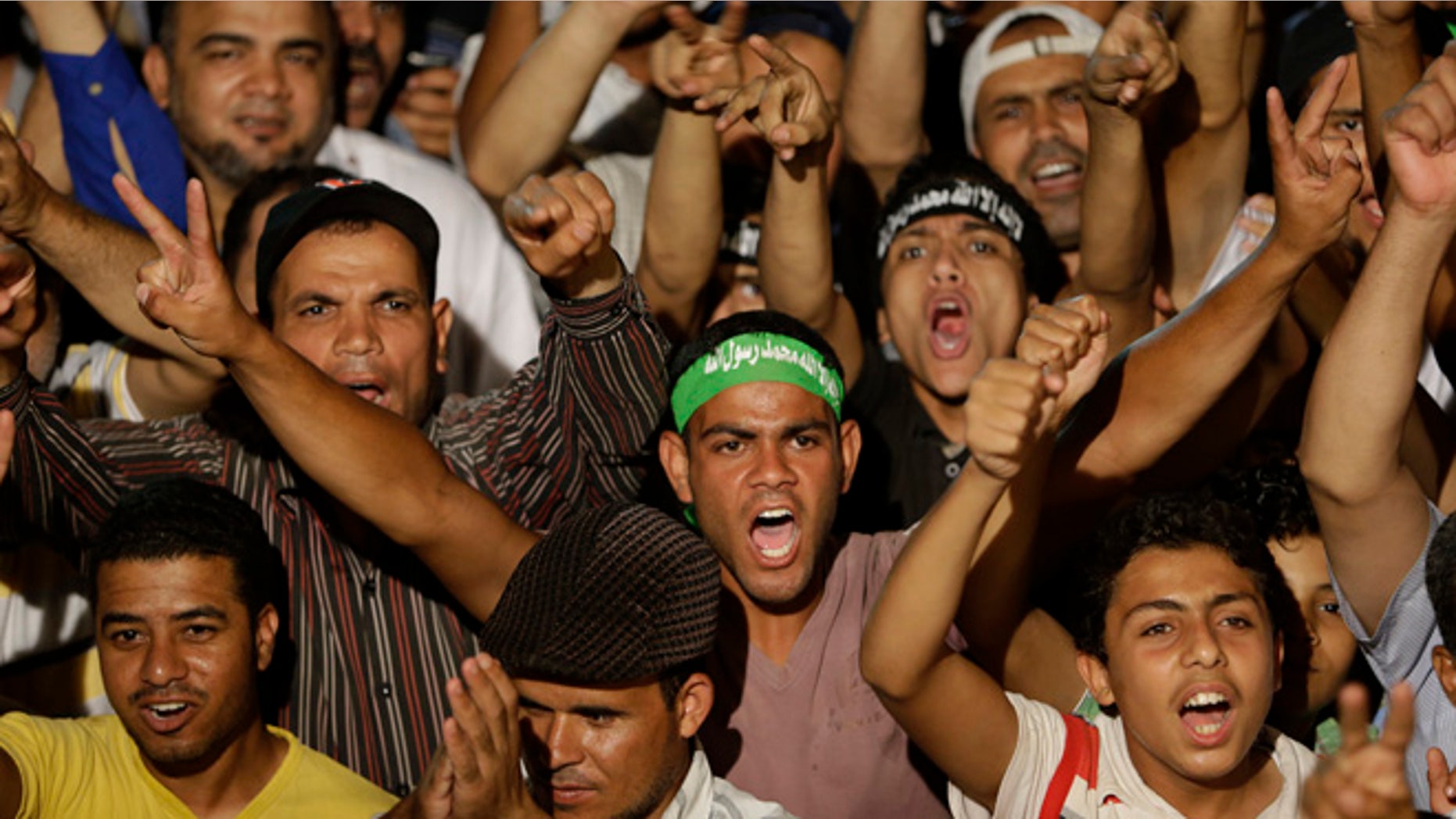 July 10, 2013: Supporters of ousted Egypt's President Mohammed Morsi shout slogans during a demonstration after the Iftar prayer, evening meal when Muslims break their fast during the Islamic month of Ramadan, in Nasr City, Cairo, Egypt.
