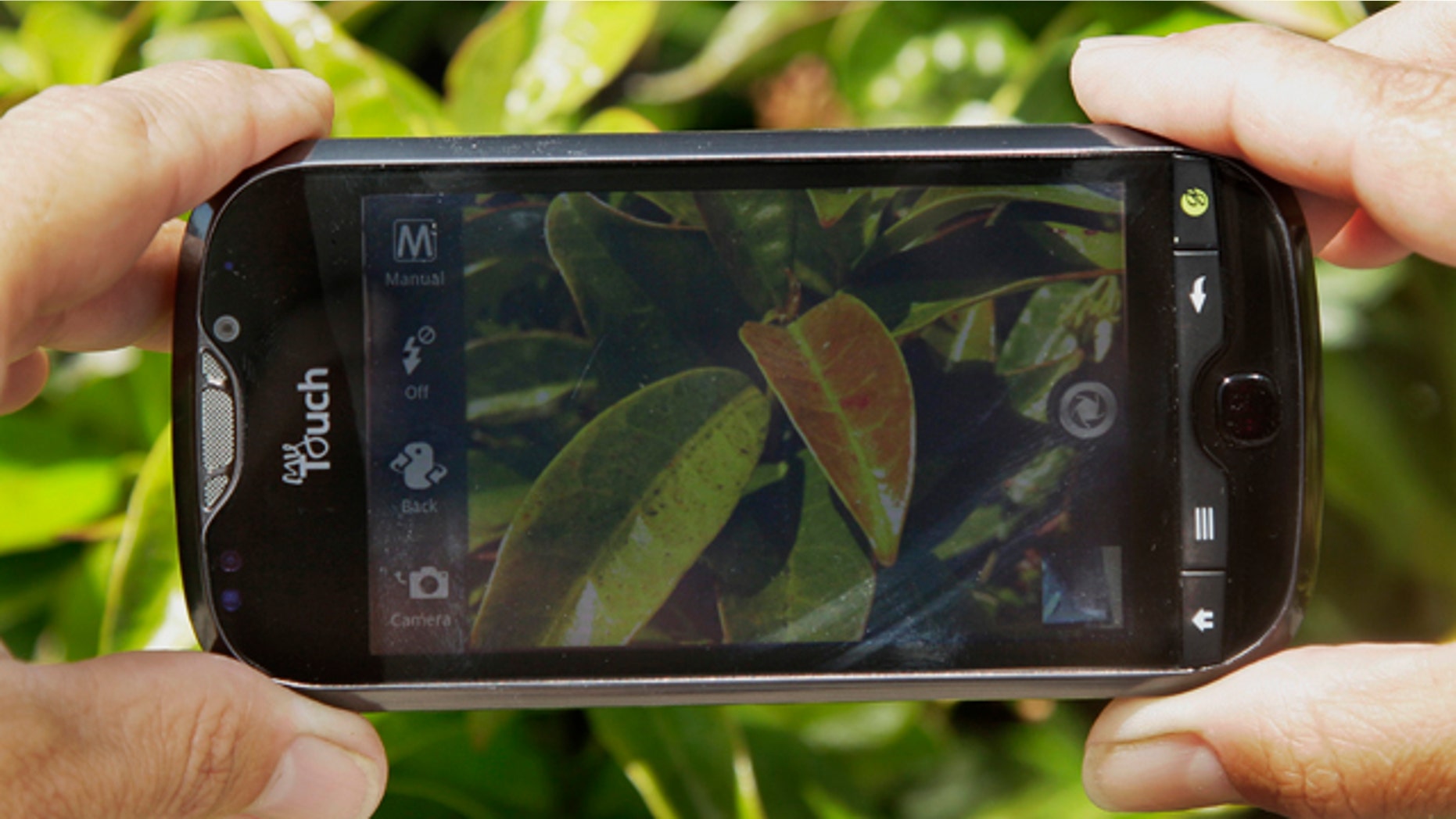Aug. 10, 2011: A reporter demonstrates the camera on the HTC myTouch 4G Slide smartphone from T-Mobile during a product review in San Francisco.