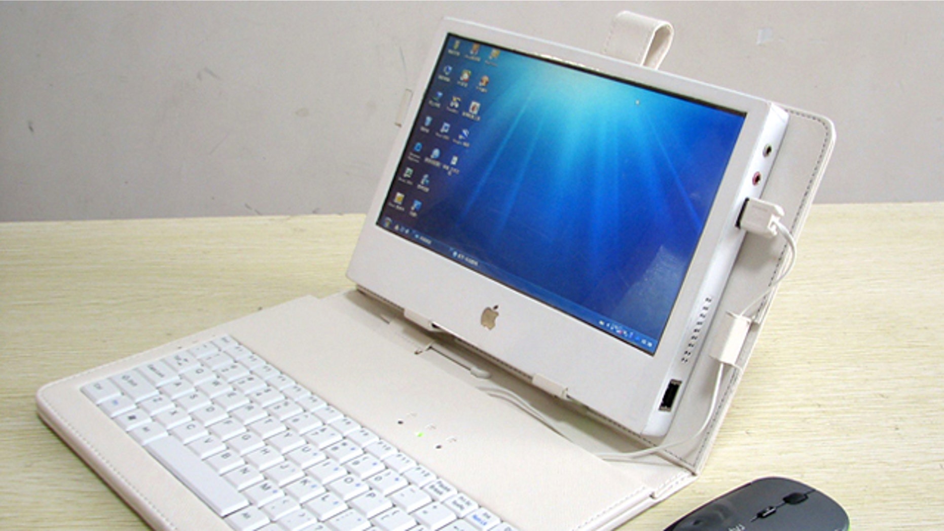 Liu Xinying's "DIY IPAD 3" touchscreen tablet computer, shown with a case, keyboard and mouse.