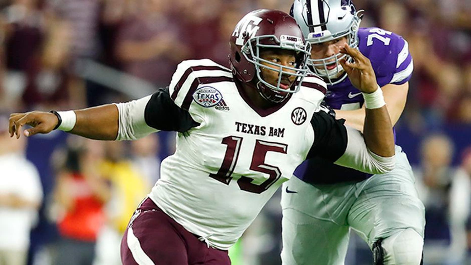Texas A&M University Aggies defensive lineman Myles Garrett (15) rushes around the edge against Scott Frantz (74) during the Texas Bowl NCAA college football game against the Kansas State University Wildcats on Wednesday, Dec. 28, 2016, in Houston. Kansas State University won 33-28. (Matt Patterson via AP)