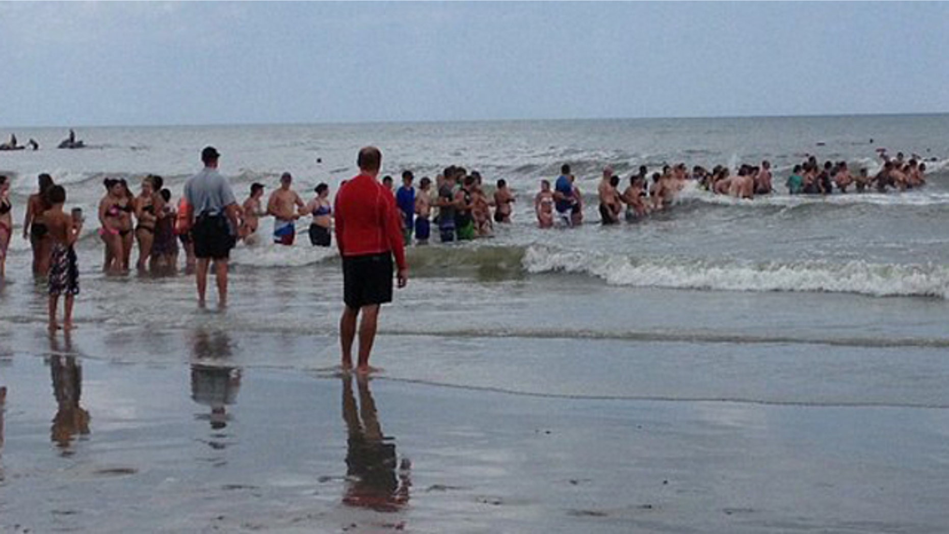 June 16, 2016: Beachgoers form a human chain to aid the search for a 14-year-old boy who vanished while swimming in Myrtle Beach, S.C.