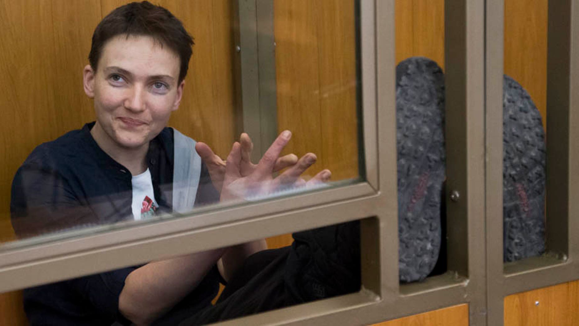 In this Tuesday, March 22, 2016 file photo Ukrainian pilot Nadezhda Savchenko looks out from a glass cage inside court, in the town of Donetsk, Rostov-on-Don region, Russia