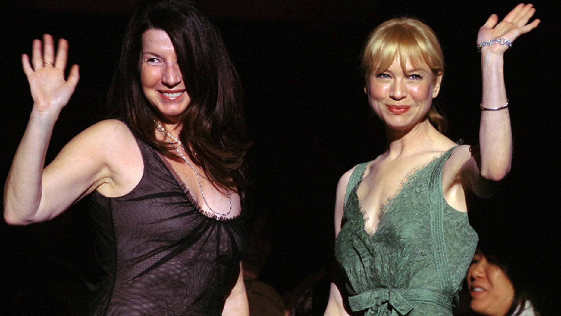 Actress Rene Zellweger, right, and publicist Nanci Ryder wave after they are acknowledged by the audience at the start of "What A Pair! 3," a concert of songs from Broadway musicals performed by duets of famous women, to benefit the Friends of the Breast Program at the University of California in Los Angles (UCLA) April 8, 2005.