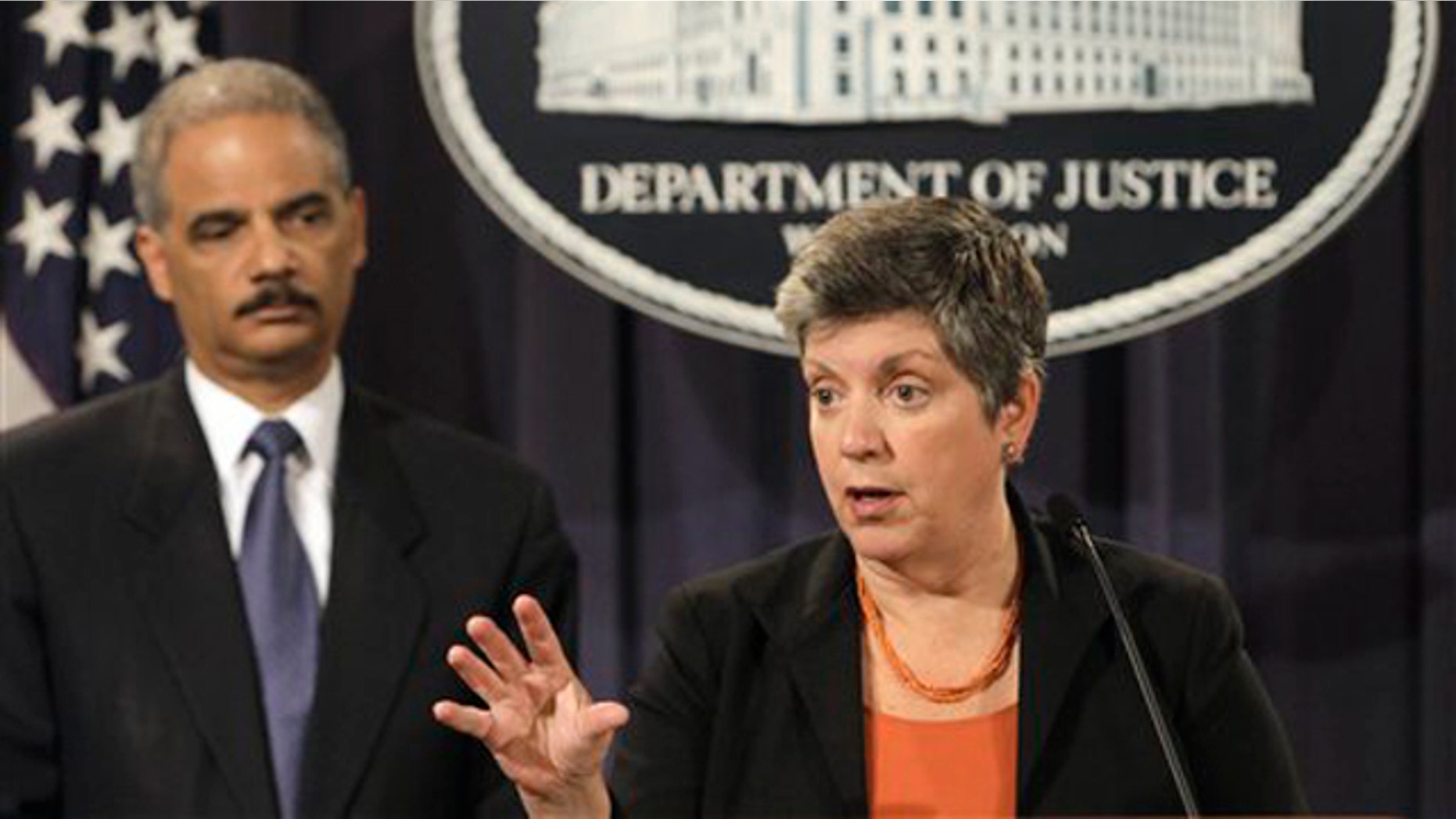 Attorney General Eric Holder, left, listens as Homeland Security Secretary Janet Napolitano speaks at the Justice Department in Washington Aug. 3.