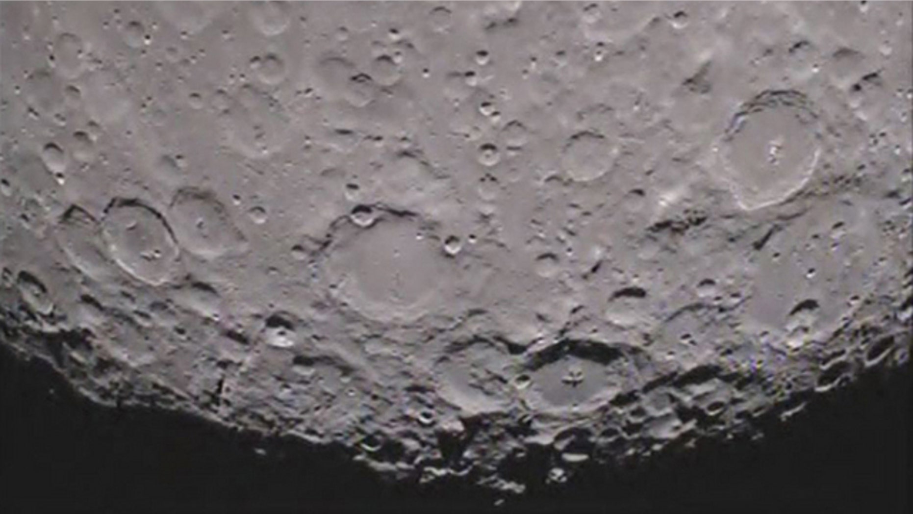 Caption:One of NASA's twin Grail spacecraft has returned its first unique picture of the far side of the moon, an image that shows shadowed craters at the moon's south pole.