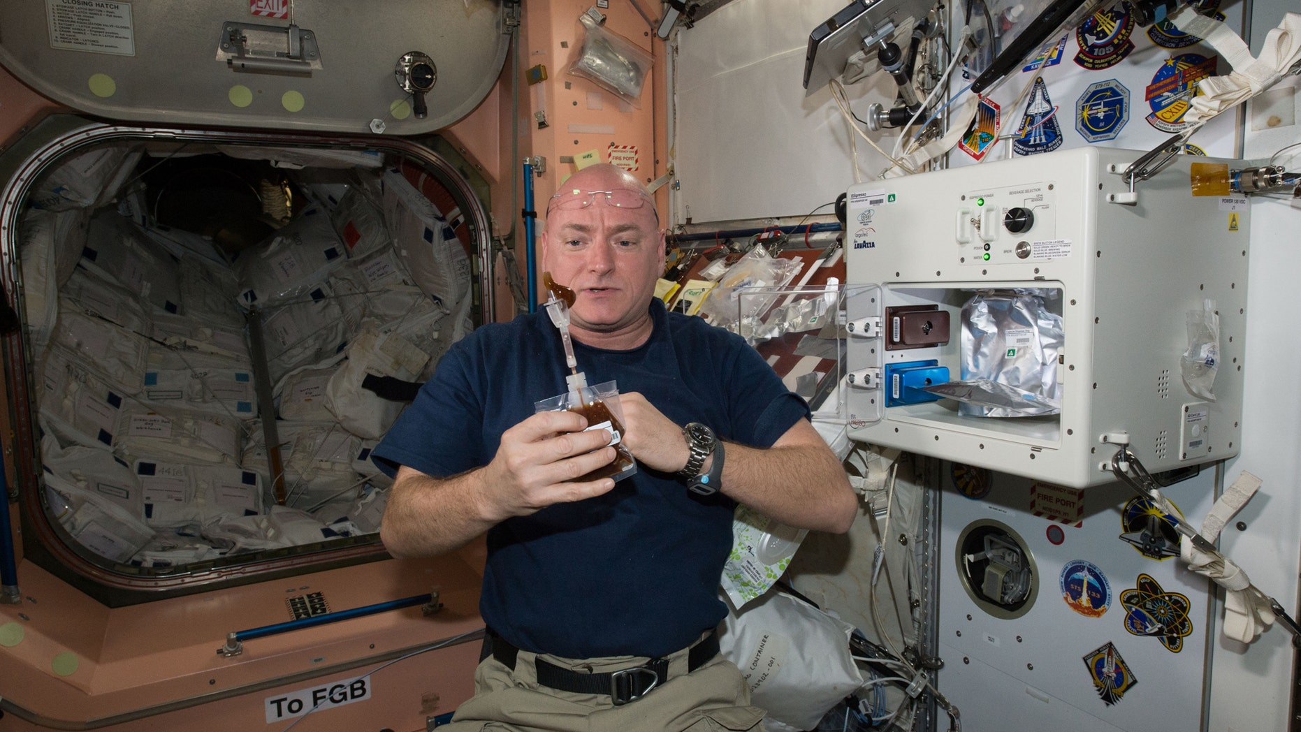 File photo: NASA astronaut Scott Kelly enjoys his first drink from the new ISSpresso machine aboard the International Space Station, May 3, 2016. The espresso device allows crews to make tea, coffee, broth, or other hot beverages they might enjoy. (REUTERS/NASA/Handout)