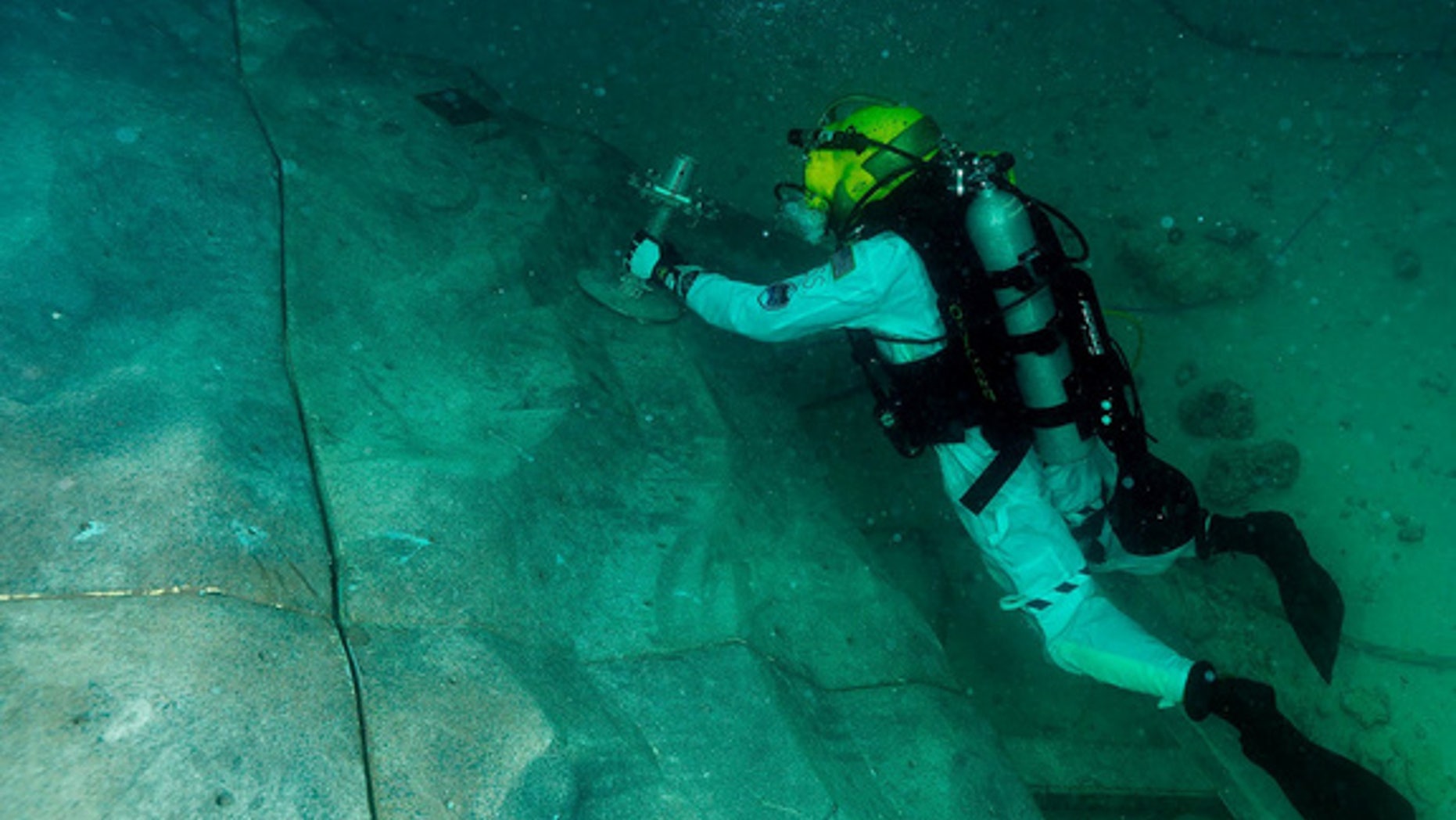 Steve Squyers maneuvers to an anchor point on "asteroid" rock wall during one of the extravehicular activities.