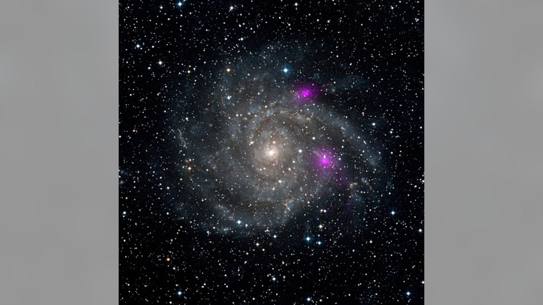 This new view of spiral galaxy IC 342, also known as Caldwell 5, includes data from NASA's Nuclear Spectroscopic Telescope Array, or NuSTAR. High-energy X-ray data from NuSTAR have been translated to the color magenta, and superimposed on a vis