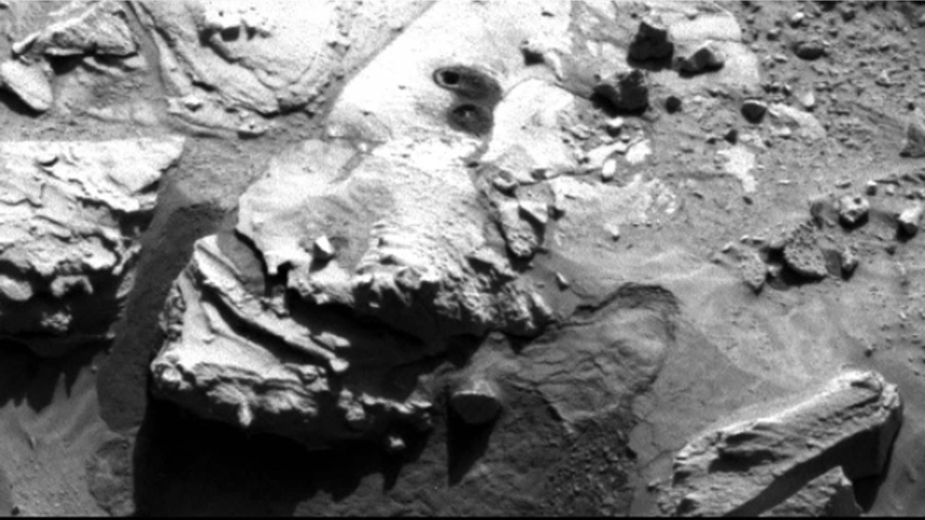 May 5, 2014: This image from the Navigation Camera on NASA's Curiosity Mars rover shows two holes at top center drilled into a sandstone target called "Windjana."