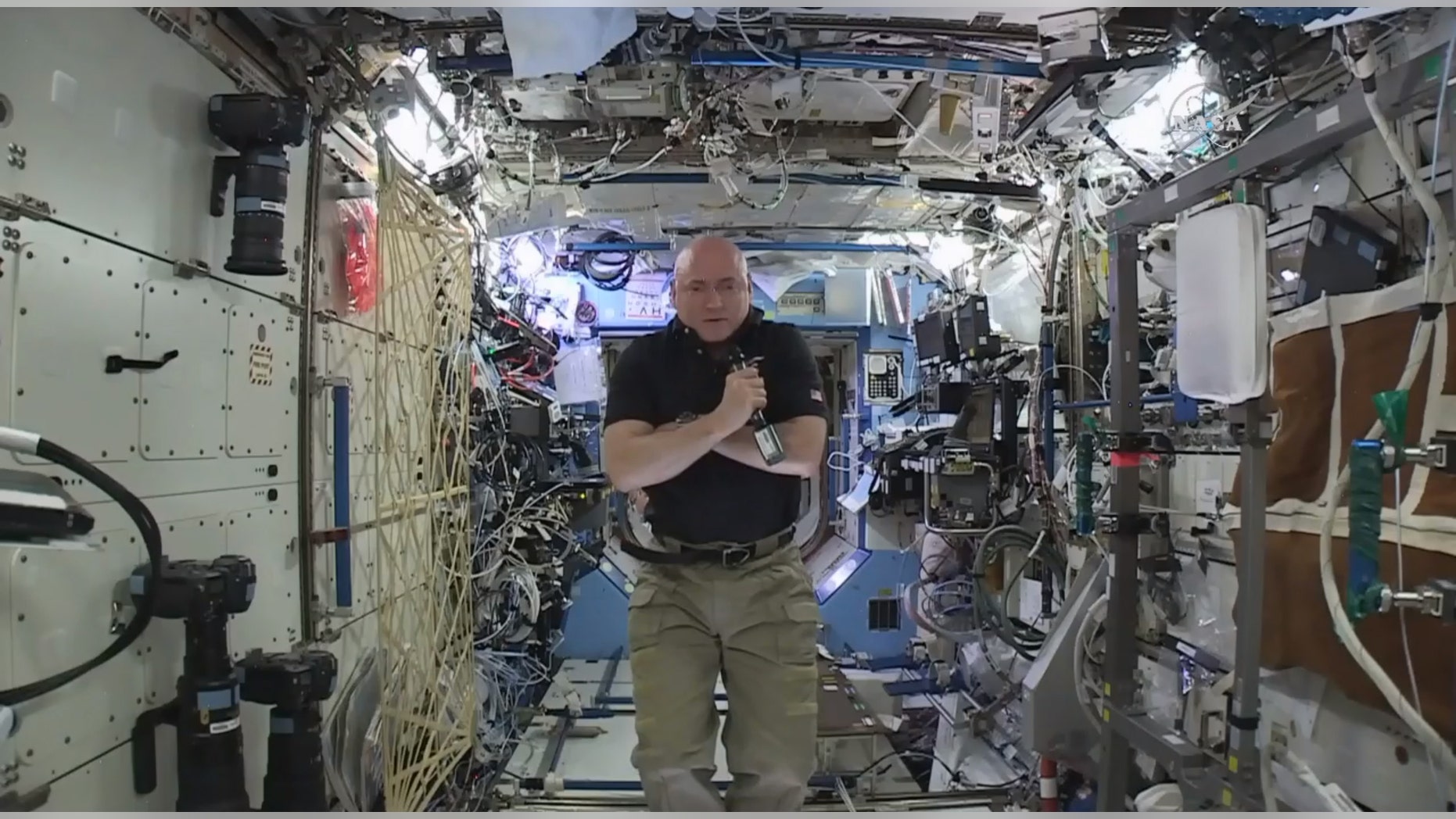 In this image from video made available by NASA, astronaut Scott Kelly speaks to reporters on Earth during a news conference held on the International Space Station on Thursday, Feb. 25, 2016. After nearly a year in space, Kelly is just a few days away from returning to Earth. He'll leave Tuesday on a Russian Soyuz capsule back to the planet to end NASA's longest space flight ever. (NASA via AP)
