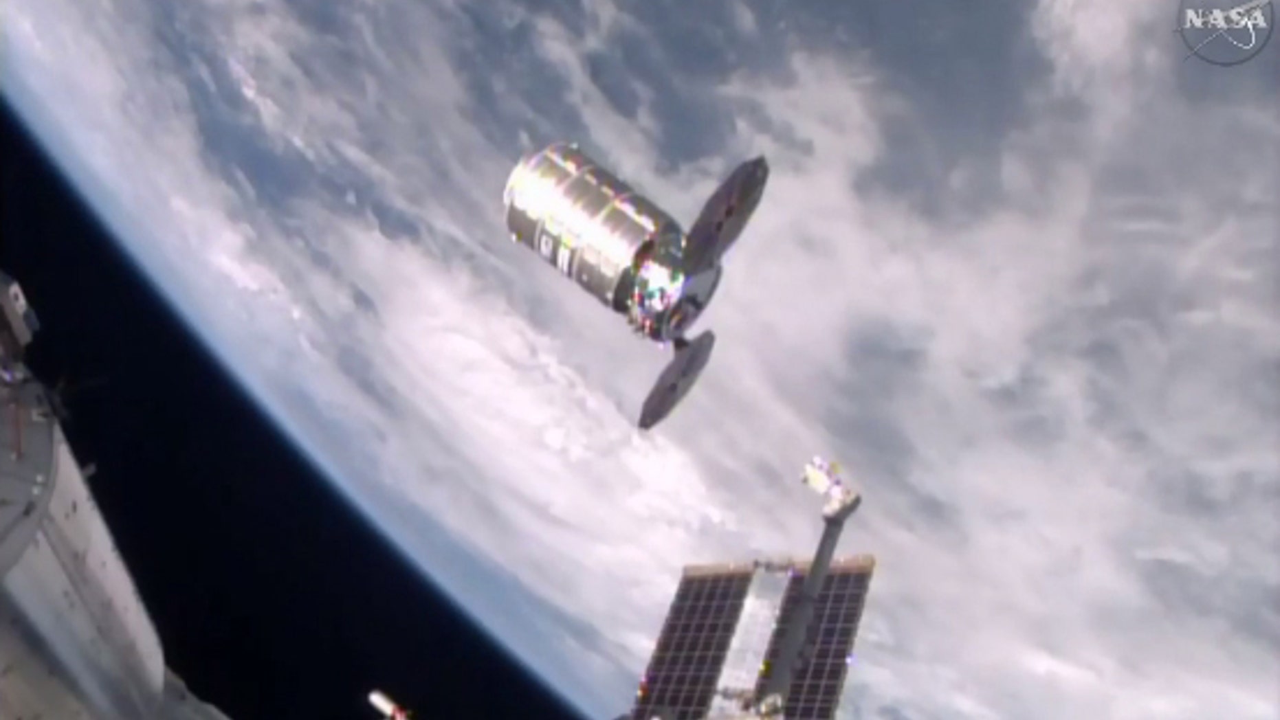This photo taken from NASA TV shows a capsule loaded with 1.5 tons of trash, released from the International Space Station on Friday, Feb. 19, 2016. NASA supplier Orbital ATK launched the capsule, named Cygnus, to the space station in December, full of food, clothes and other goods. Astronauts removed the precious contents, then filled it with garbage for incineration. The spacecraft should re-enter the atmosphere and burn up harmlessly over the Pacific on Saturday. (NASA via AP)